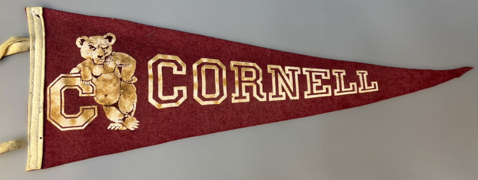 Antique 1940s Cornell University 23" Felt & Wool College Football Pennant: Great original pennant. See all photos for a better idea on condition. PLEASE NOTE WE OFFER IN HOUSE SHIPPING & HAVE BIDDING AVAILABLE ON OUR OWN WEBSITE! If you win on LIVE AUCTIONEERS, please click
