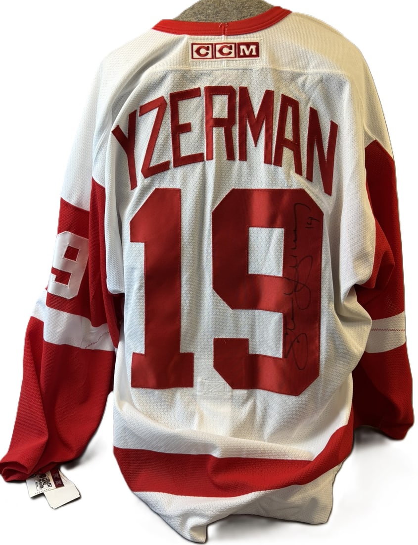 Steve Yzerman Signed Detroit Red Wings NWT CCM Jersey #19: Offered here is a Steve Yzerman autographed Detroit Red Wings CCM jersey featuring the iconic number 19 on the back.This white Red Wings jersey displays bold red tackle-twill lettering spelling “