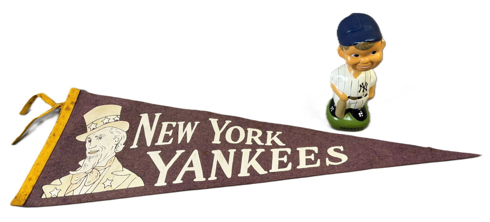 New York Yankees Baseball Felt Uncle Sam Pennant & Bobblehead Lot: Great original pair of New York Yankees related items. Full size Uncle Sam Pennant and bobblehead. PLEASE NOTE WE OFFER IN HOUSE SHIPPING & HAVE BIDDING AVAILABLE ON OUR OWN WEBSITE! If you win on LIV