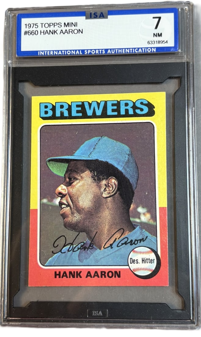 1975 Topps Mini #660 Hank Aaron HOF ISA 7 NM Near Mint: ISA GRADED 7 Cert #63318954 PLEASE NOTE WE OFFER IN HOUSE SHIPPING & HAVE BIDDING AVAILABLE ON OUR OWN WEBSITE! If you win on LIVE AUCTIONEERS, please click "SELF ARRANGED SHIPPING" when you receive y