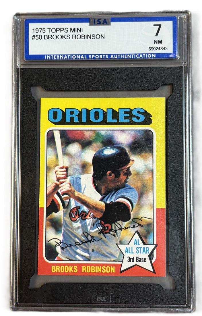 1975 Topps Mini #50 Brooks Robinson HOF ISA 7 NM Near Mint: ISA GRADED 7 Cert #69024843 PLEASE NOTE WE OFFER IN HOUSE SHIPPING & HAVE BIDDING AVAILABLE ON OUR OWN WEBSITE! If you win on LIVE AUCTIONEERS, please click "SELF ARRANGED SHIPPING" when you receive