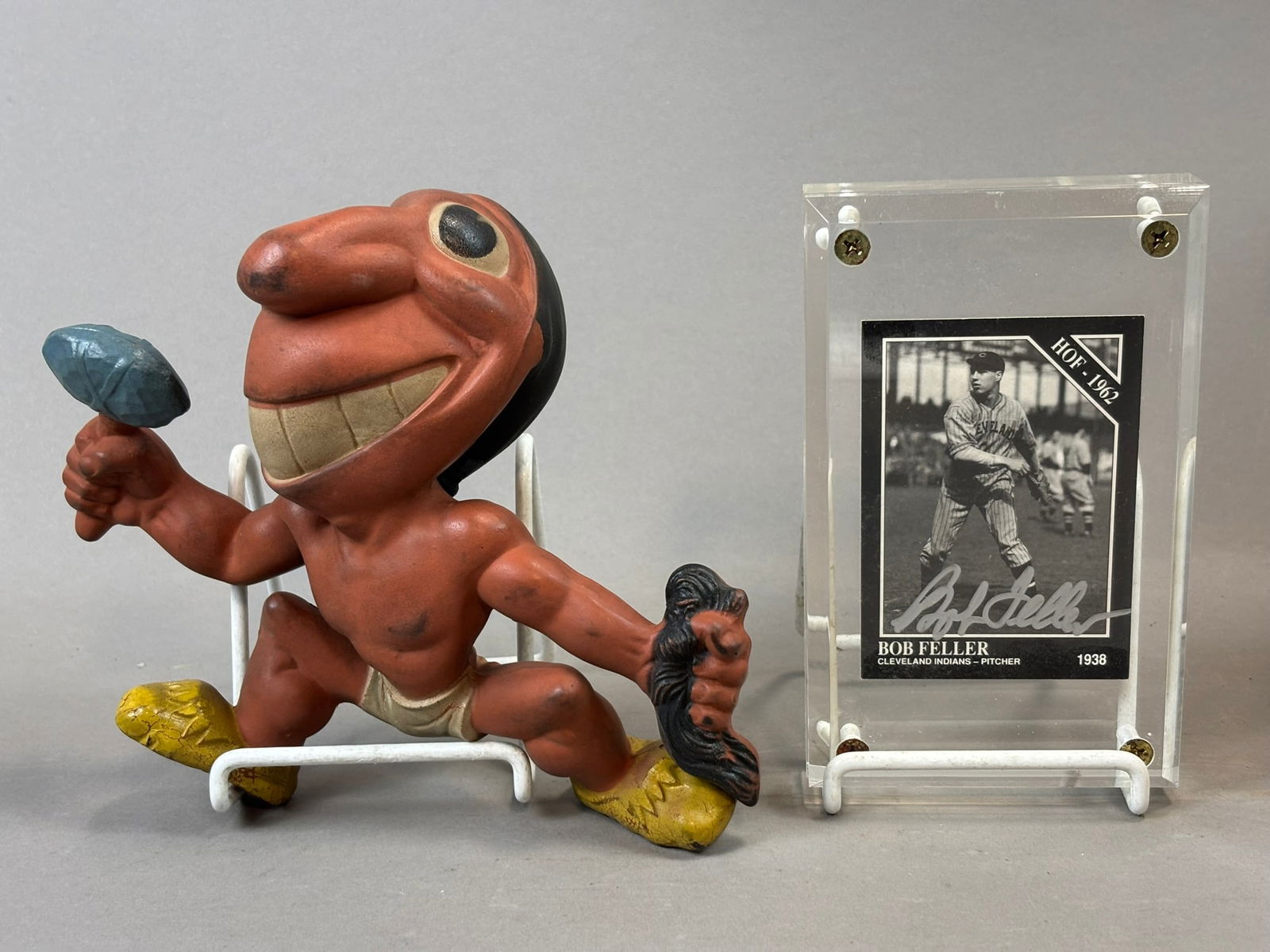 Pair Cleveland Indians Chief Wahoo & Bob Feller Signed HOF 1962 Card: Great original Indians lot. Strong bold Feller auto. PLEASE NOTE WE OFFER IN HOUSE SHIPPING & HAVE BIDDING AVAILABLE ON OUR OWN WEBSITE! If you win on LIVE AUCTIONEERS, please click "SELF ARRANGED