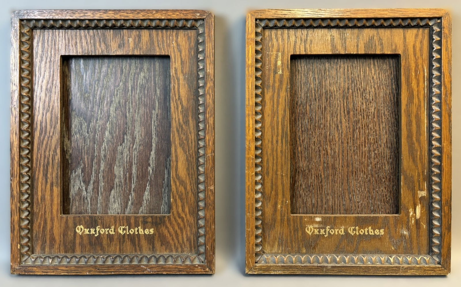 Pair Oxxford Clothes Early 20th Century Wooden Store Display Advertising Frames: Offered here is a handsome pair of early 20th century Oxxford Clothes wooden store display advertising frames. Each frame features rich quarter-sawn oak construction with a deep inset display opening,