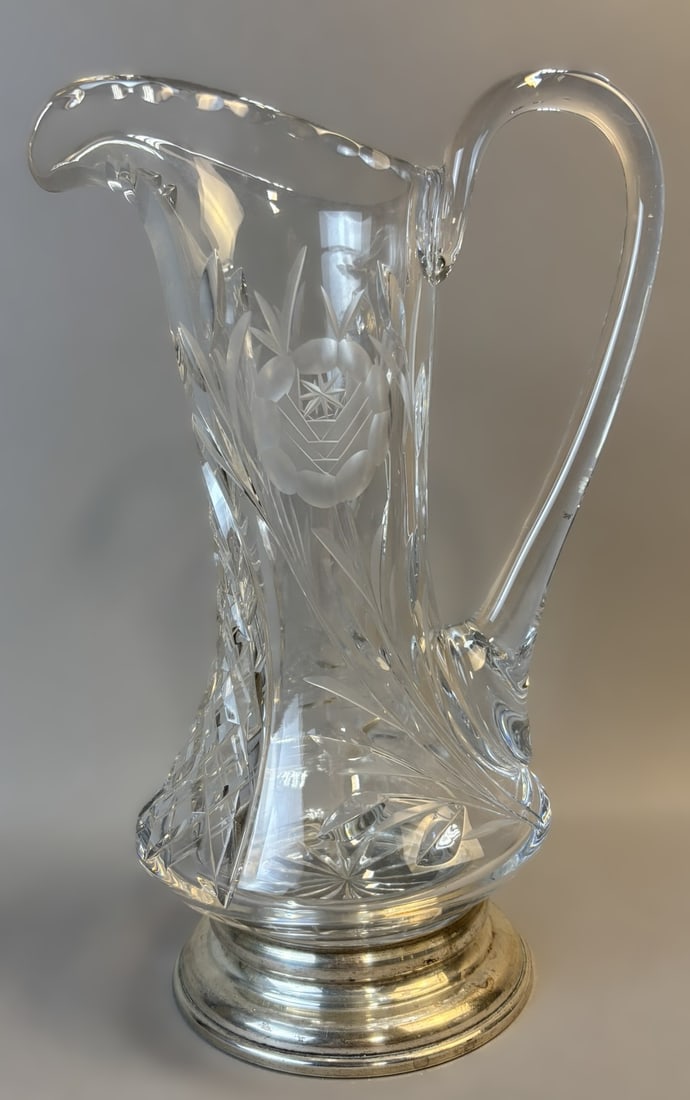 Brilliant Cut Crystal Pitcher w/ Sterling Silver Base 11.5": Offered here is a striking brilliant cut crystal water pitcher mounted in a sterling silver base. The pitcher features finely executed deep cut decoration including floral and geometric motifs, crossh