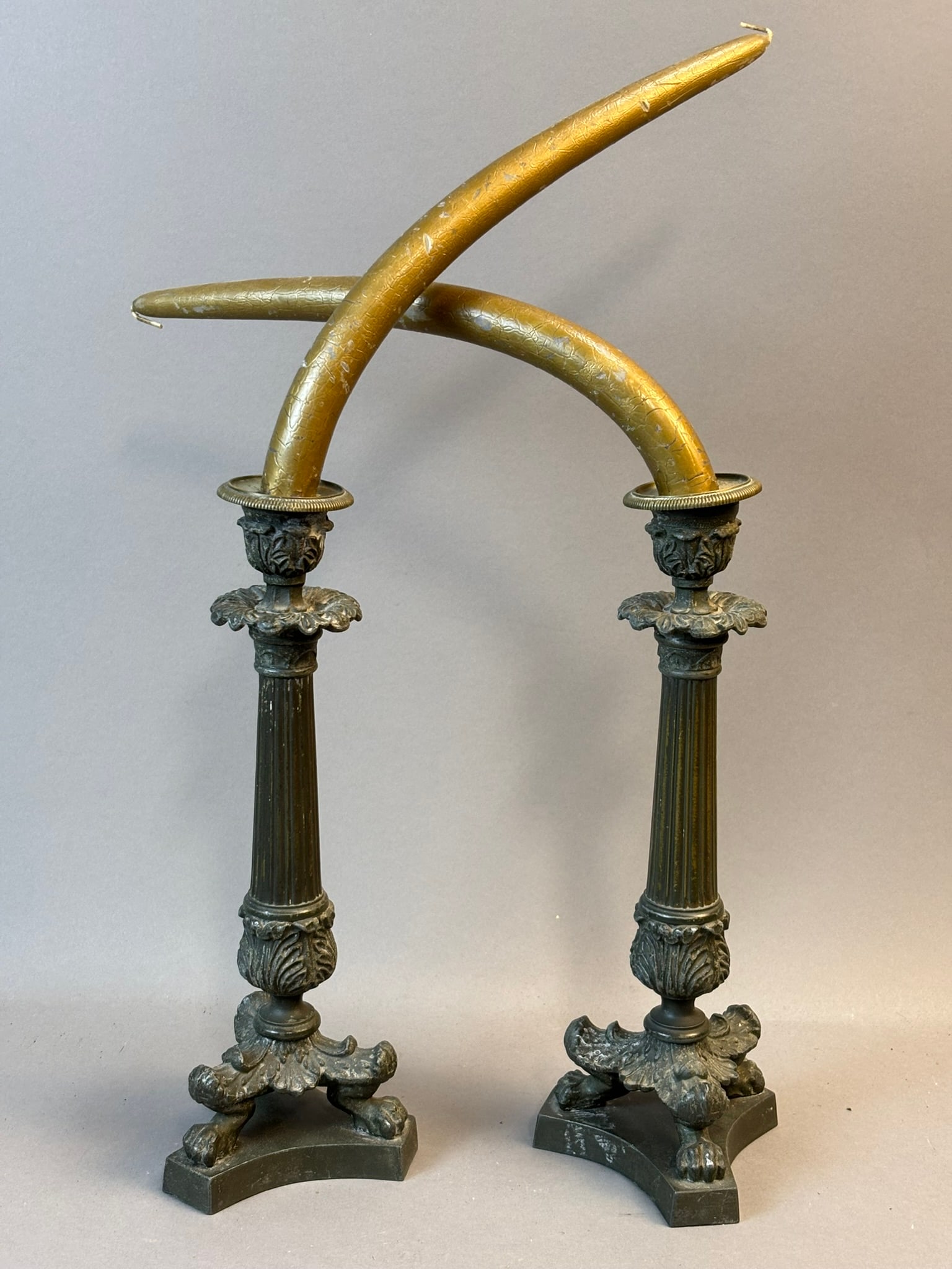 Pair Antique 11" 19th Century Brass Candlesticks w/ Claw Feet: Striking pair of antique brass candlesticks, standing an impressive 11 inches tall and measuring approximately 4" x 4" at the base. Each features a fluted central column rising from a bold tripod base