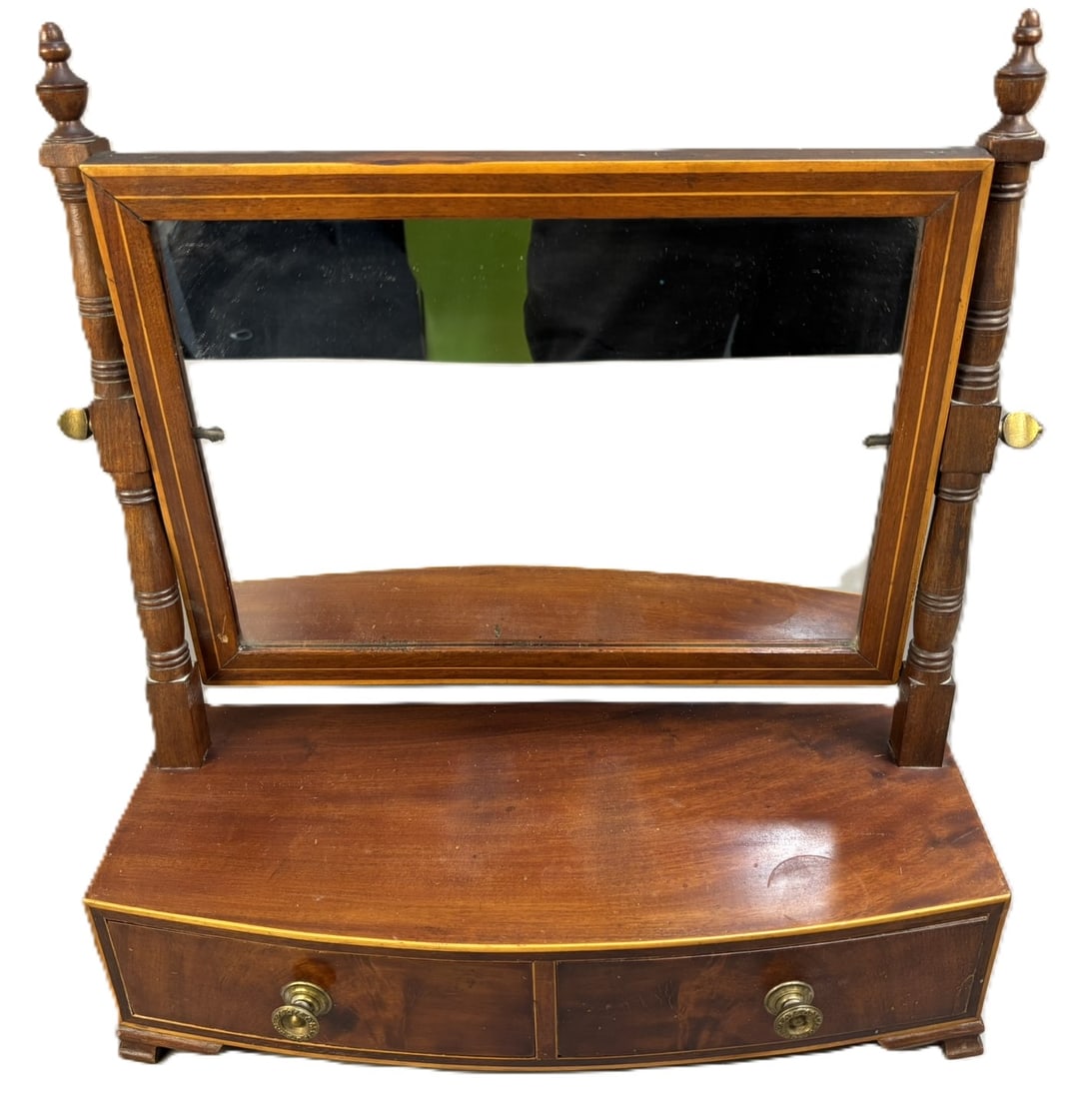 Antique Late 19th Century Mahogany Vanity Mirror Cabinet w/ Drawers: A charming antique-style mahogany vanity mirror cabinet featuring a gracefully curved front and warm, richly toned finish. The adjustable mirror is framed by turned side supports with brass tension kn