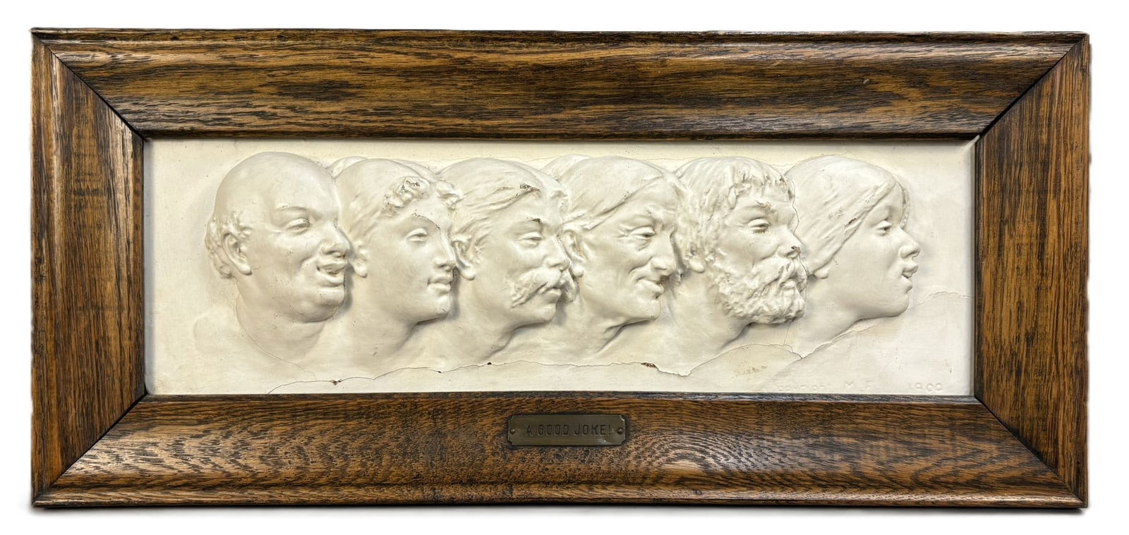 Late 19th C. Plaster Relief “A Good Joke” Framed Wall Plaque: Charming late 19th to early 20th century plaster relief wall plaque titled “A Good Joke.” This expressive composition features a row of finely modeled male profiles, each face capturing a