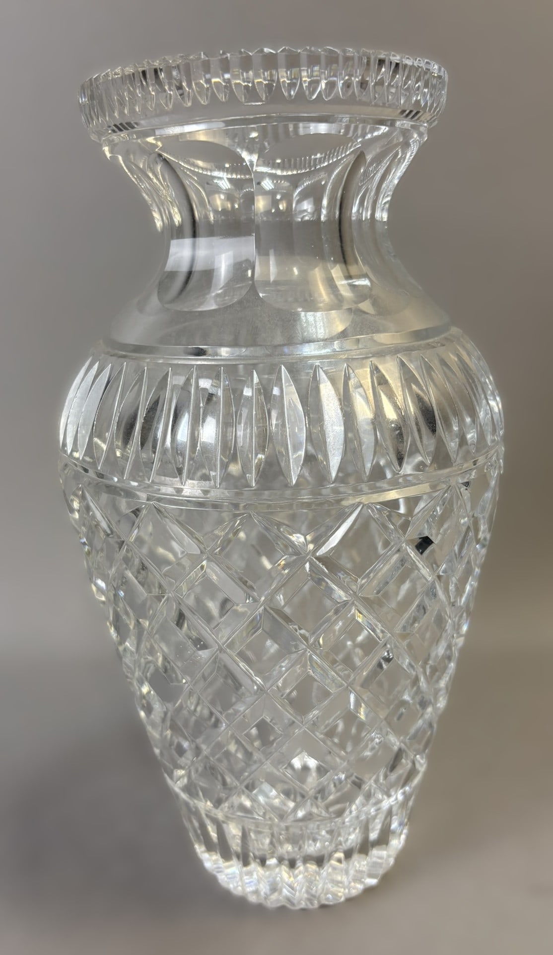 Heavy Cut Crystal Vase 10.5" Tall Diamond & Thumbprint Pattern: An impressive heavy cut crystal vase featuring a classic and richly detailed design. Standing approximately 10.5 inches tall and measuring about 5.5 inches across the rim, this substantial piece displ
