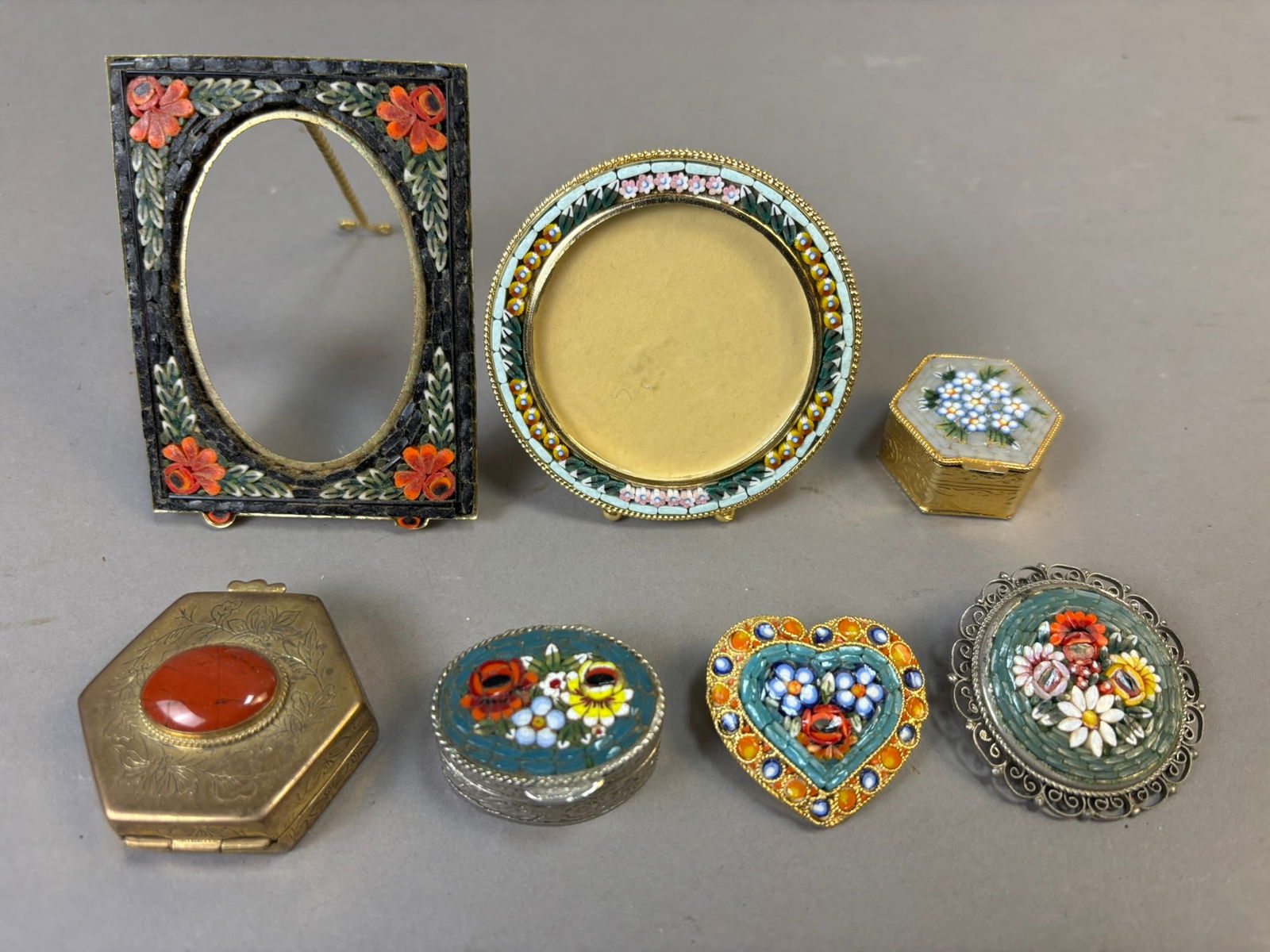 Antique Italian Micro Mosaic Pill Boxes & Framed Brooches Lot: A charming and highly decorative collection of seven antique and vintage Italian micro mosaic pieces, including pill boxes and framed brooches. This delightful grouping showcases the intricate craftsm