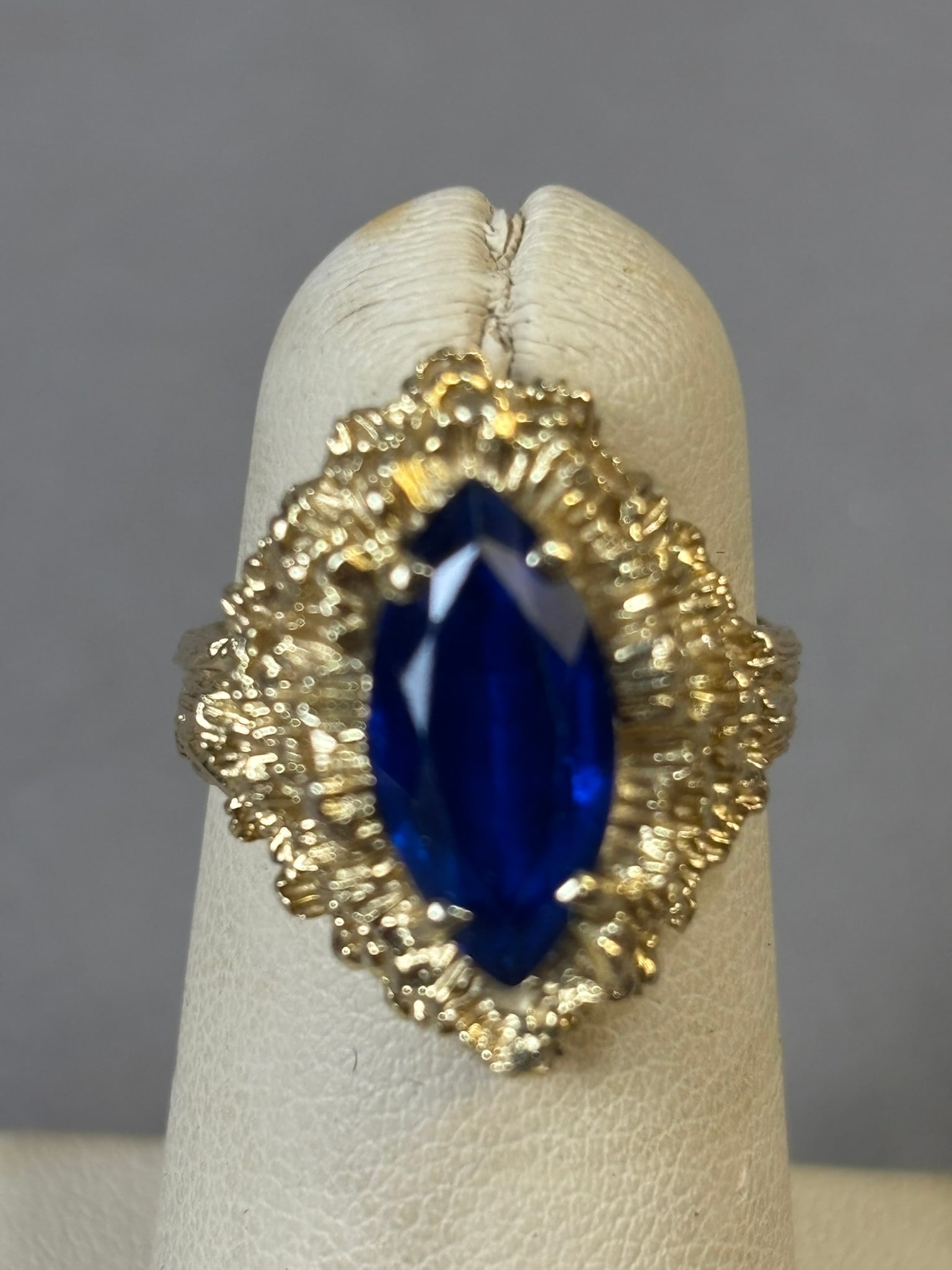 14K Gold Marquise Sapphire Cocktail Ring 9.2 Grams Size 7.5: Size 7.5 - Elegant and bold 14K yellow gold cocktail ring set with a striking marquise-cut sapphire. The deep royal blue stone displays excellent saturation and brilliance, beautifully contrasted by t