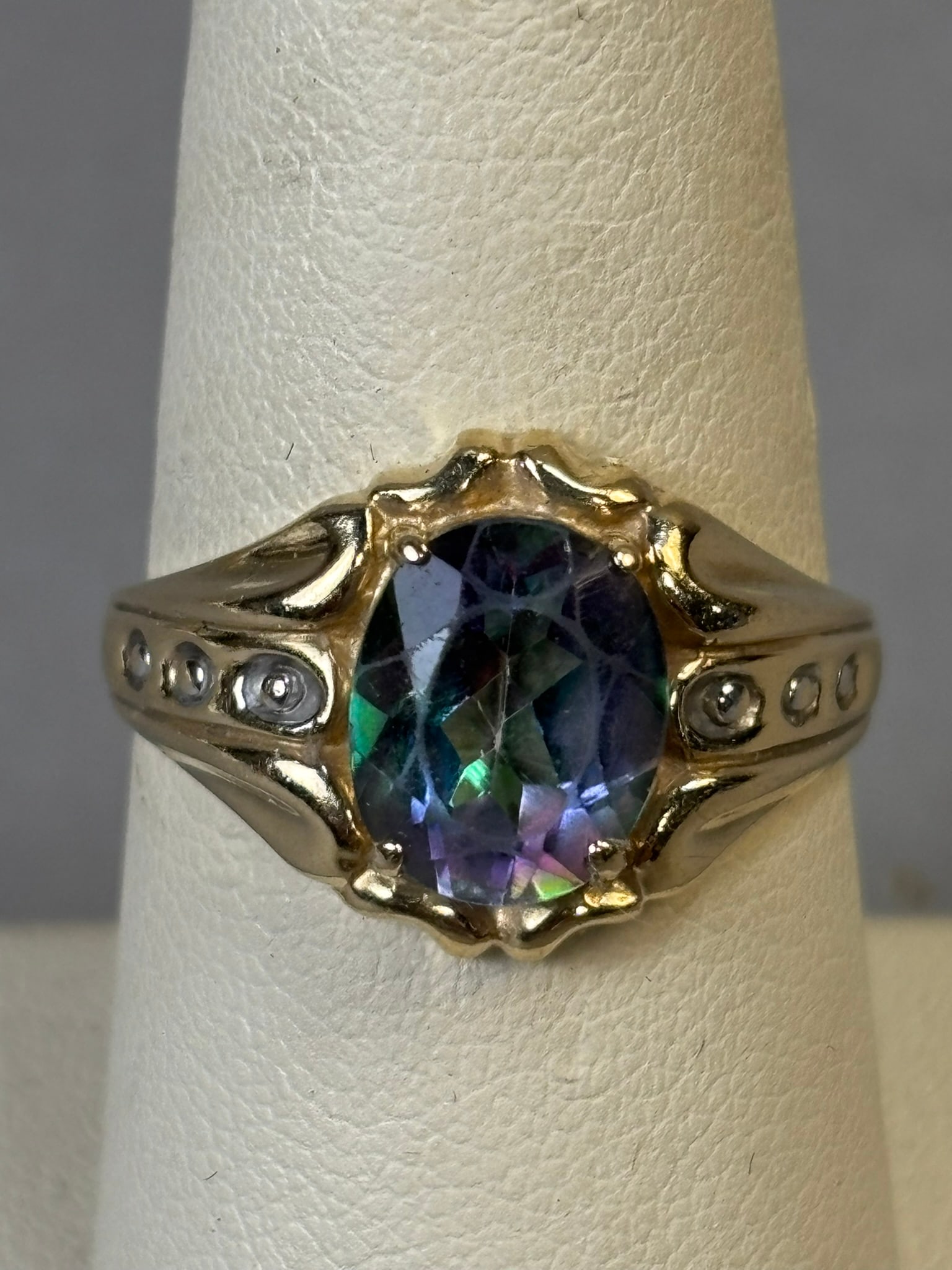 10K Gold Mystic Topaz Ring Oval Cut Statement Ring Size 9.5 3.45g: 10K yellow gold ring set with an oval faceted mystic topaz displaying vivid iridescent green, purple, and blue coloration. The stone is mounted in a raised multi-prong setting with sculpted shoulders