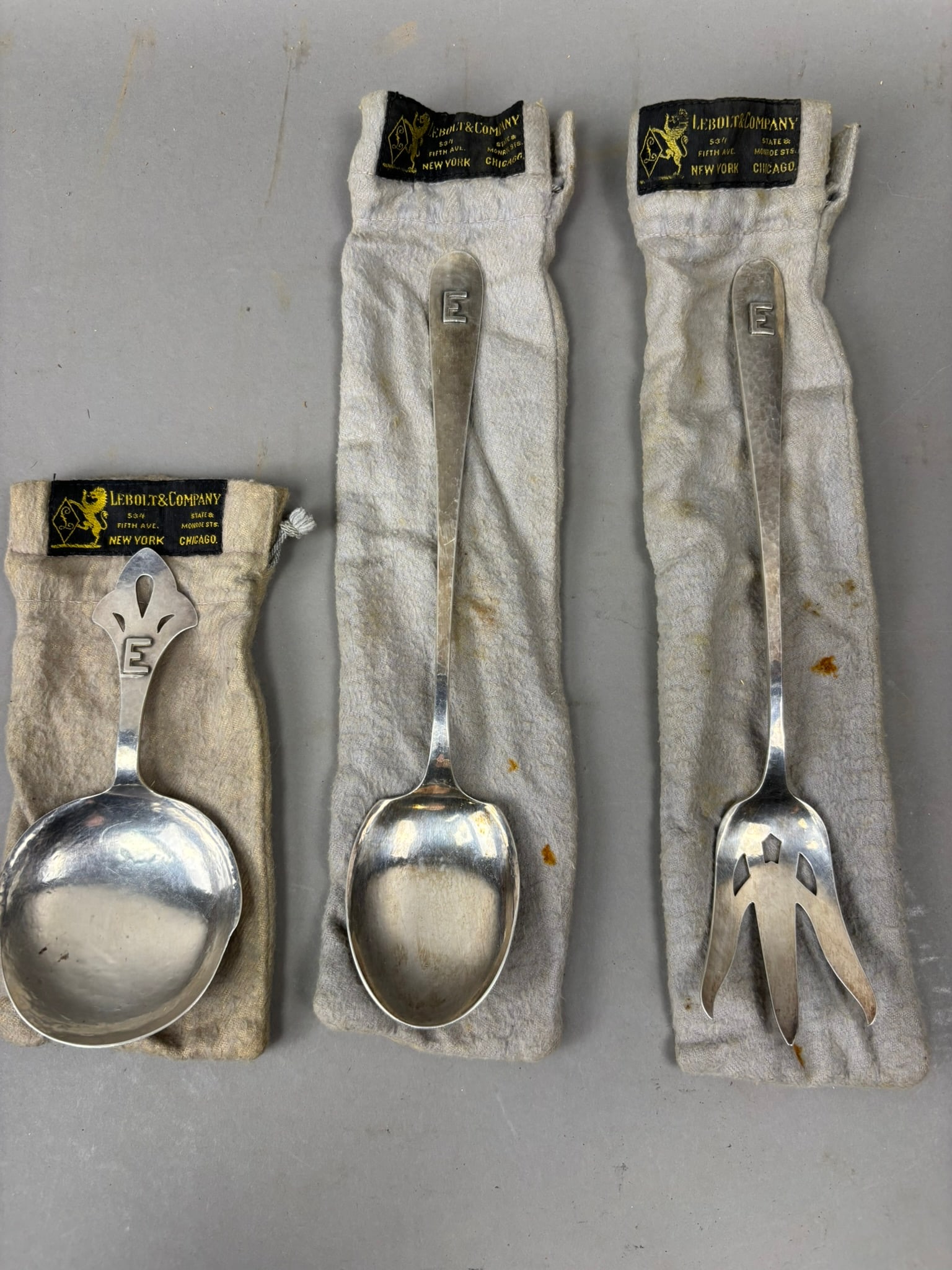 Lebolt Sterling Silver Hand Made Serving Spoon Set w Fork 198g Total: Group of three Lebolt & Company hand made sterling silver serving utensils including a large serving spoon, a smaller sauce or berry spoon, and a pierced serving fork, each bearing the stamped mark