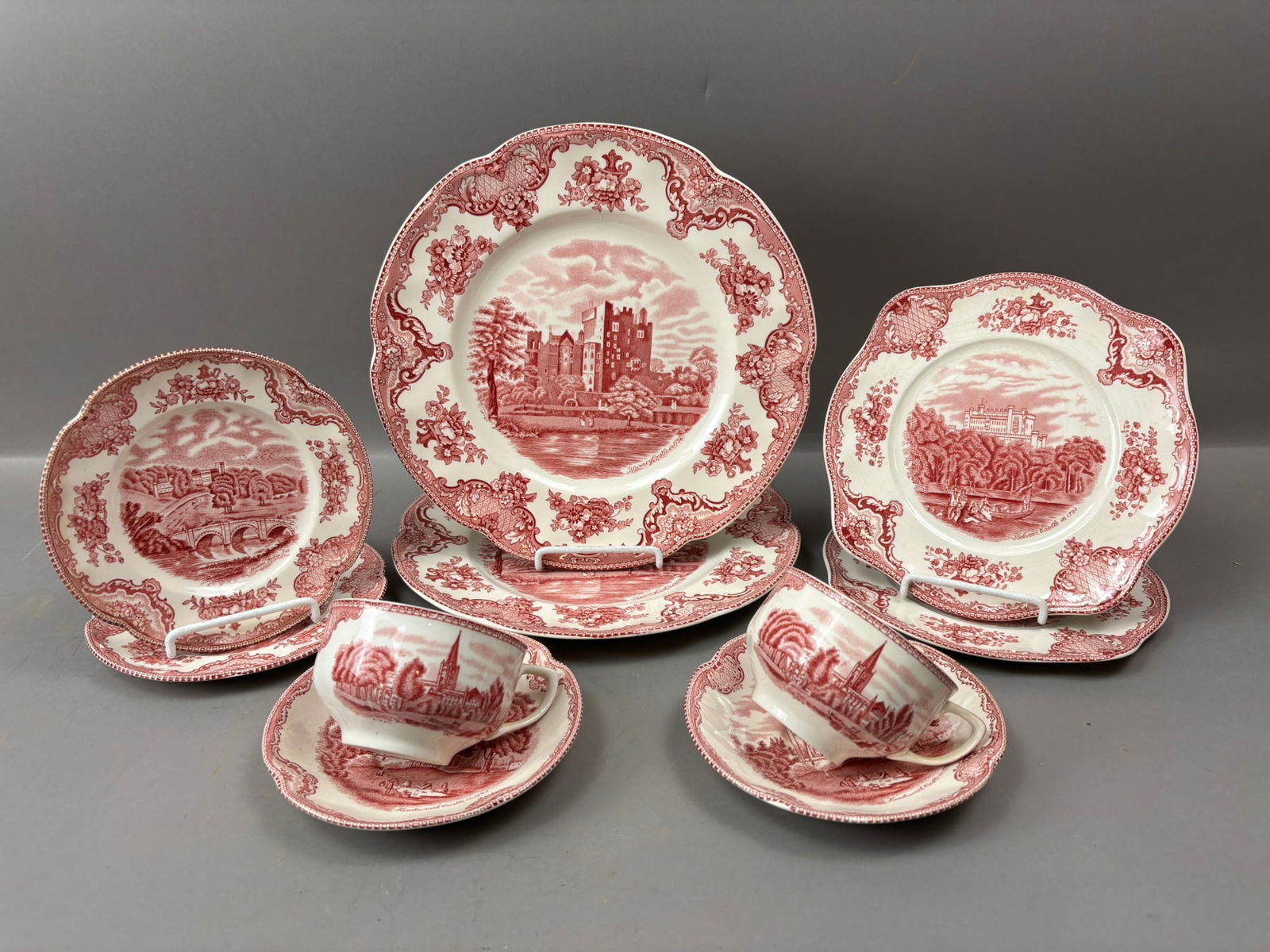 19th Century 10 Pc Johnson Bros Old Britain Castles Red Transferware Set: Group of ten pieces of Johnson Bros “Old Britain Castles” red transferware ironstone made in England. The lot includes assorted plates along with teacups and saucers, each decorated with d