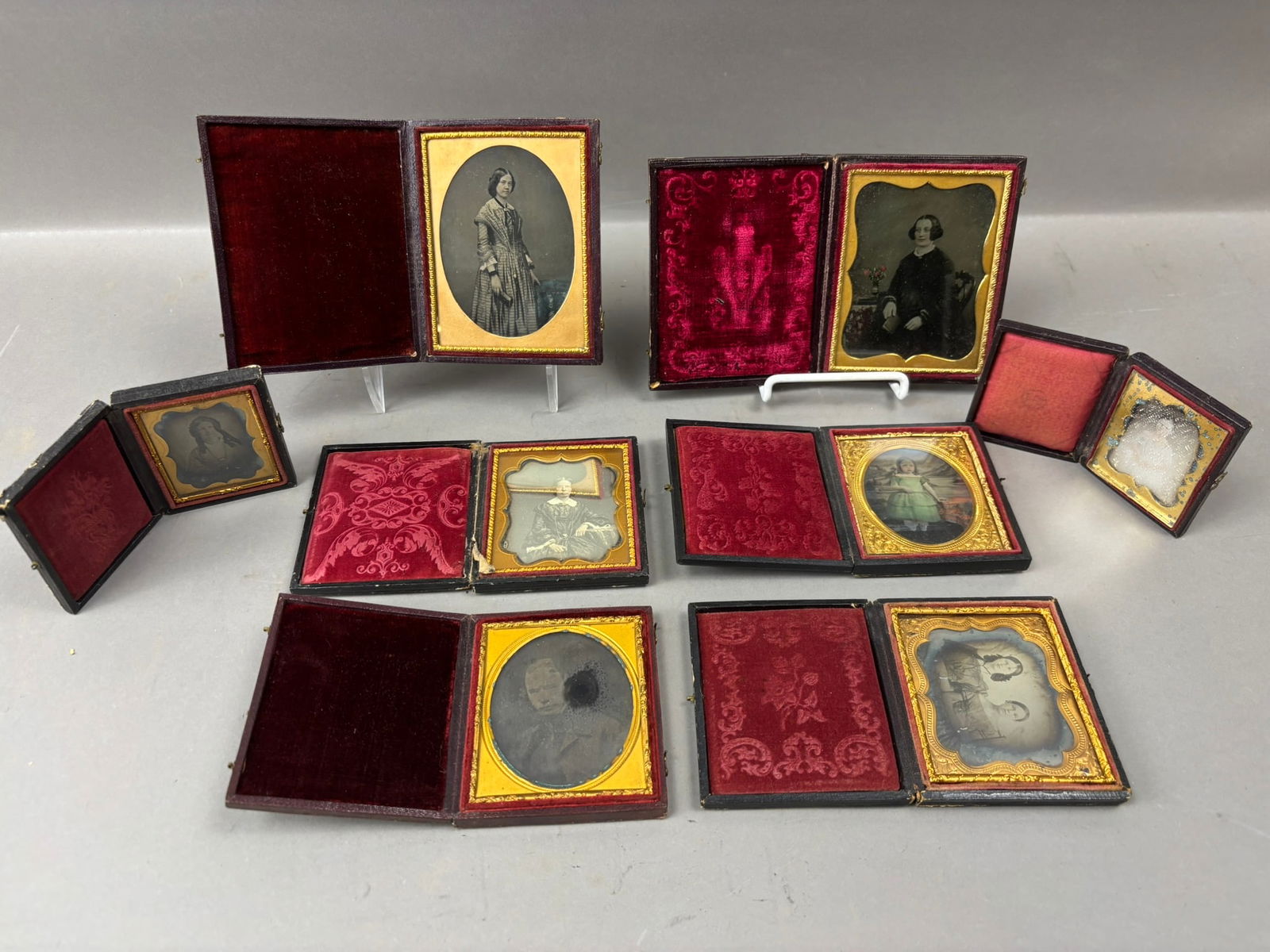 Eight Antique Daguerreotype & Ambrotype Photos in Union & Thermoplastic Cases: Collection of eight 19th century cased photographs, including daguerreotypes, ambrotypes, and tintypes, housed in period leather, thermoplastic, and union cases with decorative embossed designs and ve