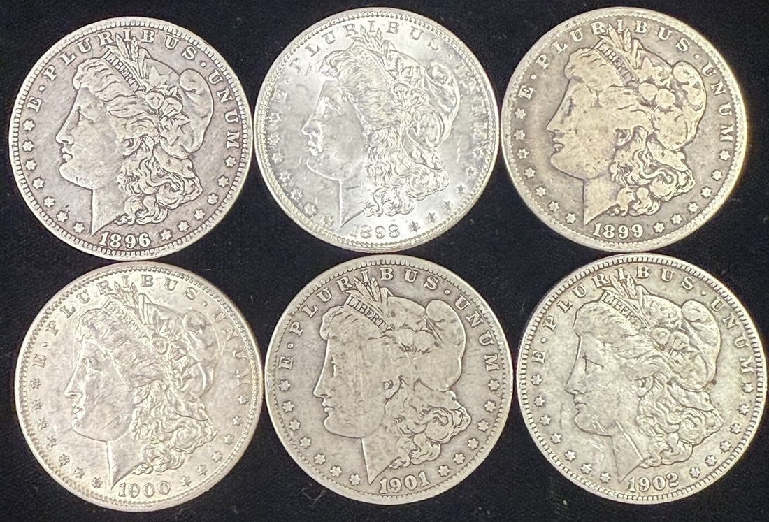 Morgan Silver Dollar Group 1896–1902 Mixed Date Collection (6): Group of six United States Morgan silver dollars including dates 1896, 1898, 1899, 1900, 1901, and 1902, each featuring the classic Liberty head obverse with E Pluribus Unum legend. Coins appear circu