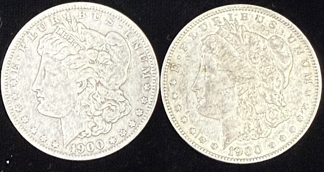 Two 1900 Morgan Silver Dollars Circulated Pair: Lot of two United States Morgan silver dollars, both dated 1900, featuring the classic Liberty head obverse with E Pluribus Unum legend and the heraldic eagle reverse. These examples show circulated c