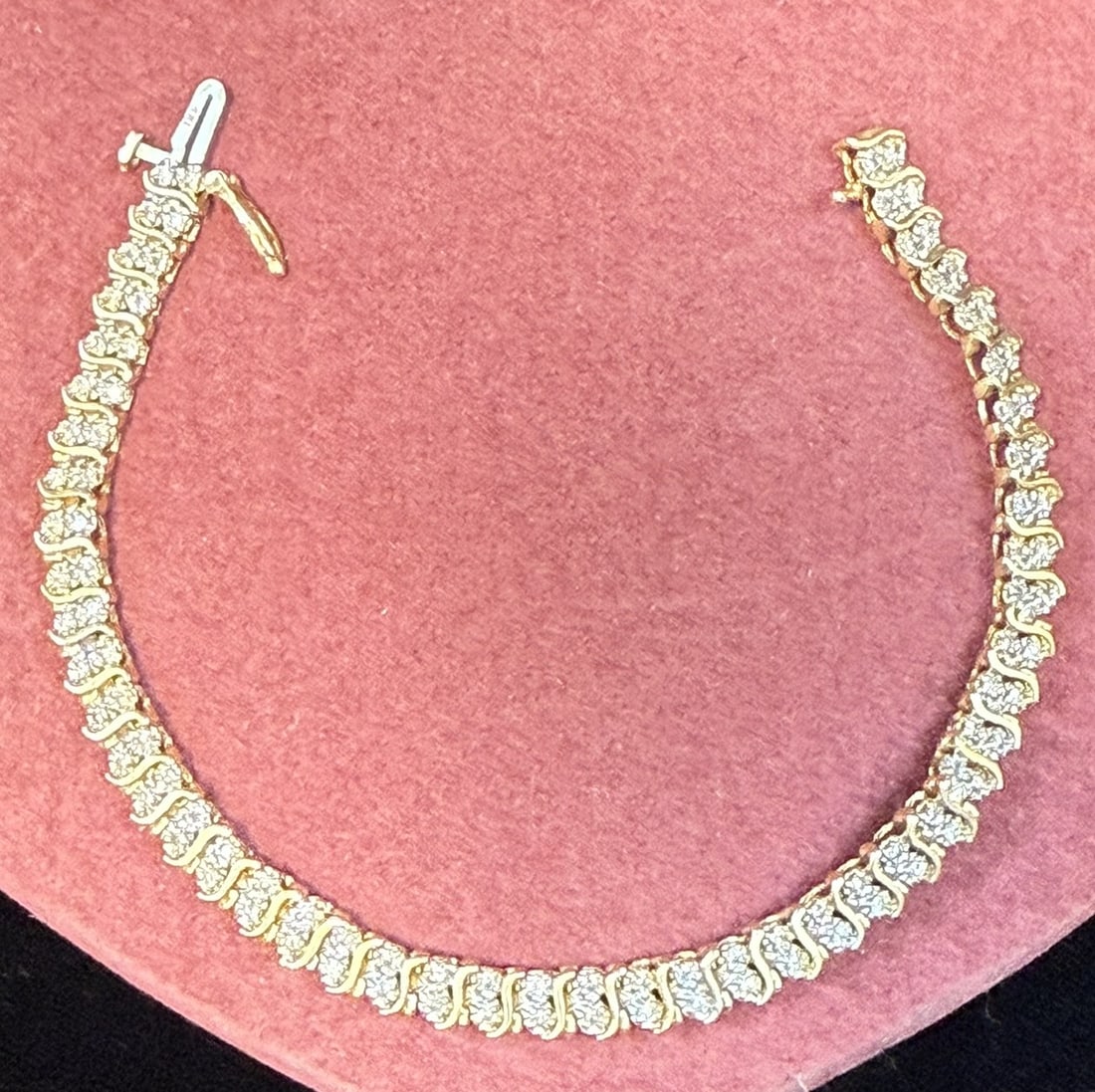 14K Gold Diamond Tennis Bracelet Round Brilliant Diamonds 7.25" 9.34g: Elegant 14K yellow gold diamond tennis bracelet featuring a continuous row of round brilliant cut diamonds set in articulated gold lib4323s with graceful curved prong settings that allow excellent lig