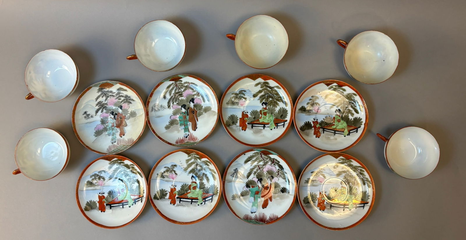 Antique Japanese Hand Painted Geisha Tea Set Cups & Saucers Nihon-sei: Antique Japanese hand painted porcelain tea set dating to the Meiji–Taisho export period circa 1900–1920. The set includes six cups and eight matching saucers decorated with finely painted