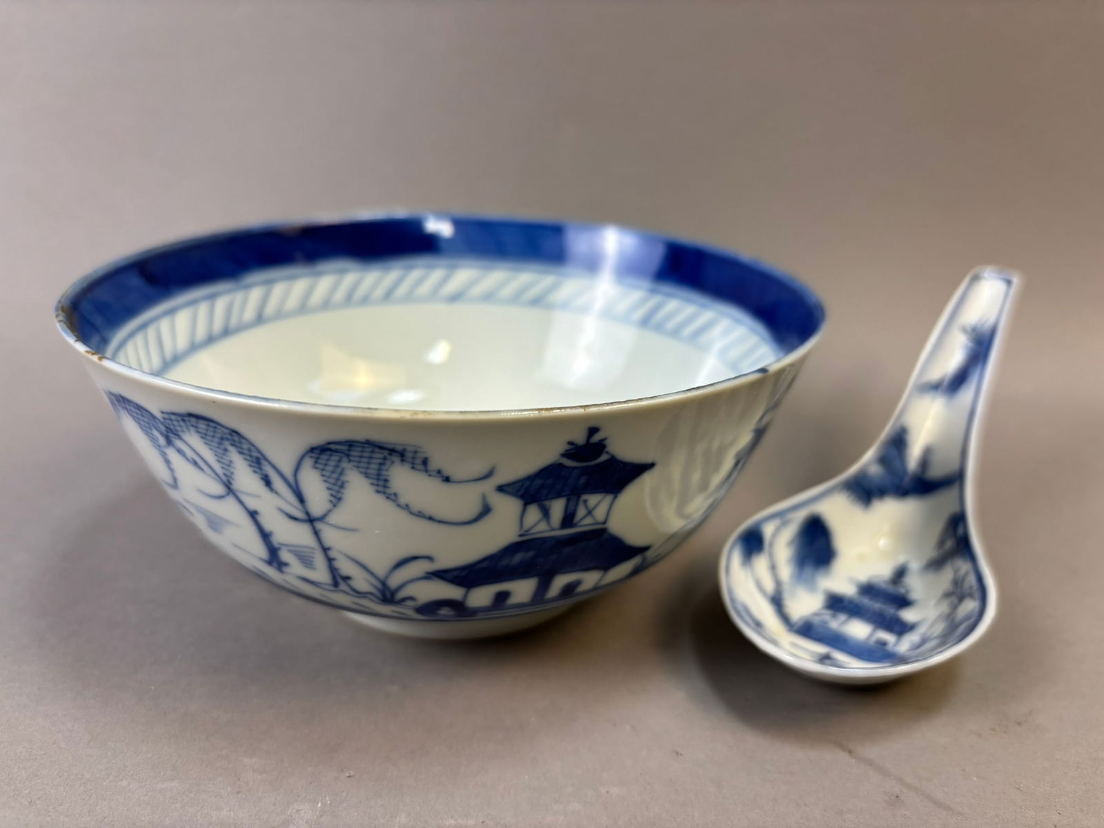 Chinese Export Blue & White Porcelain Rice Bowl & Spoon c.1900: Chinese export blue and white porcelain rice bowl accompanied by a matching porcelain spoon, dating to the late Qing Dynasty or early 20th century, circa 1890–1910. The bowl is hand decorated in