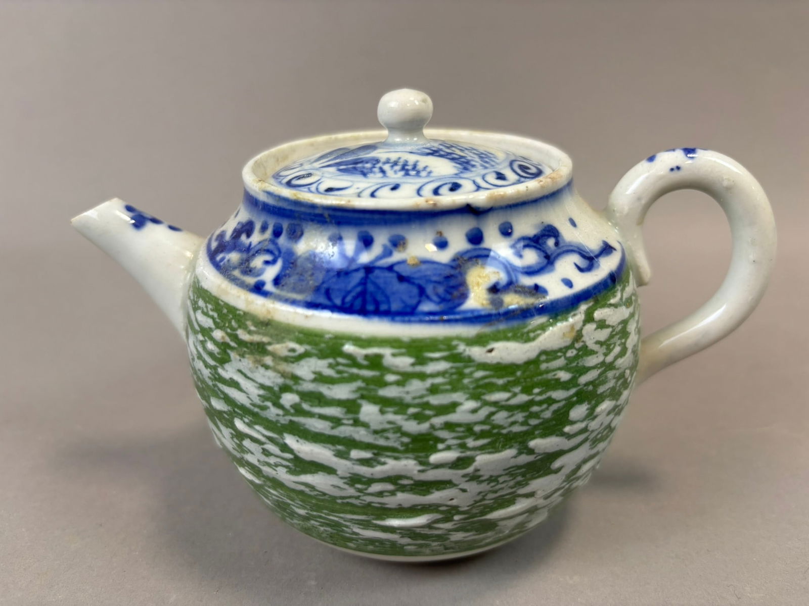 Chinese Export Miniature Porcelain Teapot Blue White Green Glaze 6in: Antique Chinese export miniature porcelain teapot featuring a rounded form with short spout, loop handle, and fitted lid with knob finial, decorated with hand-painted cobalt blue landscape motifs alon