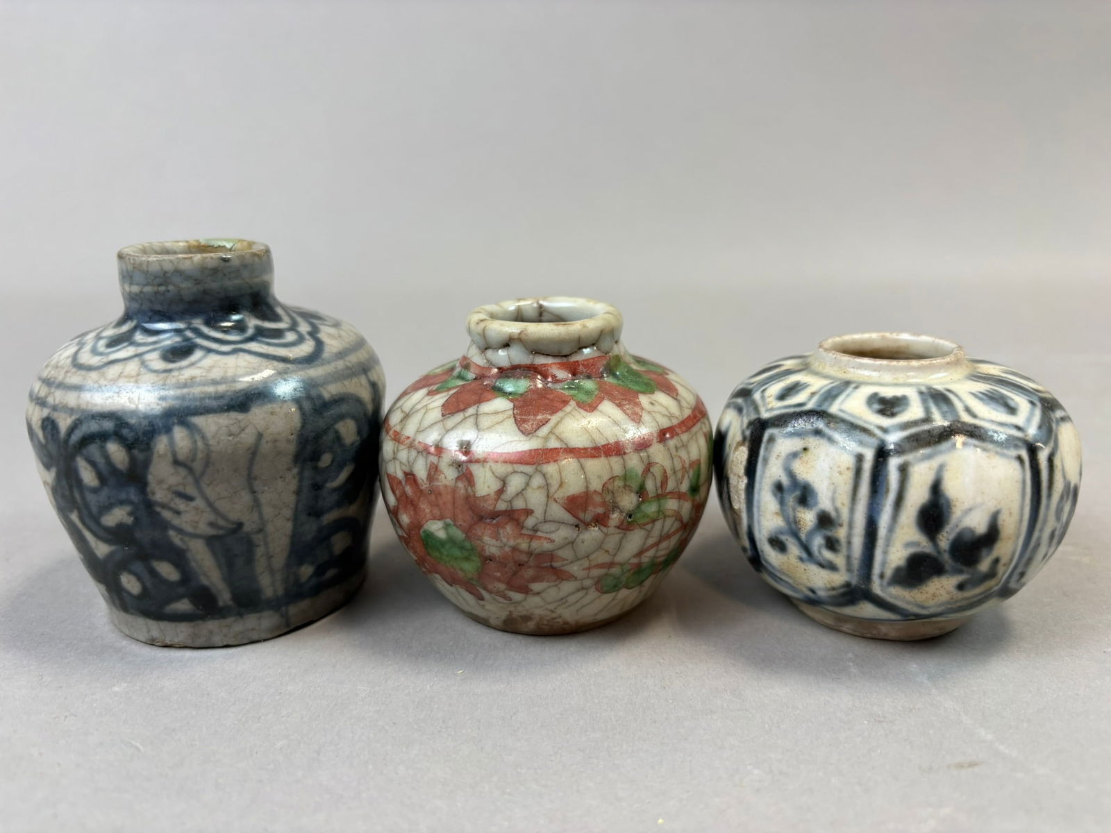 Three Chinese Miniature Crackle Glaze Porcelain Vases Blue White & Enameled: Group of three antique Chinese miniature porcelain vases featuring traditional decorative techniques including underglaze blue painting and polychrome enamel decoration over pronounced crackle glaze.