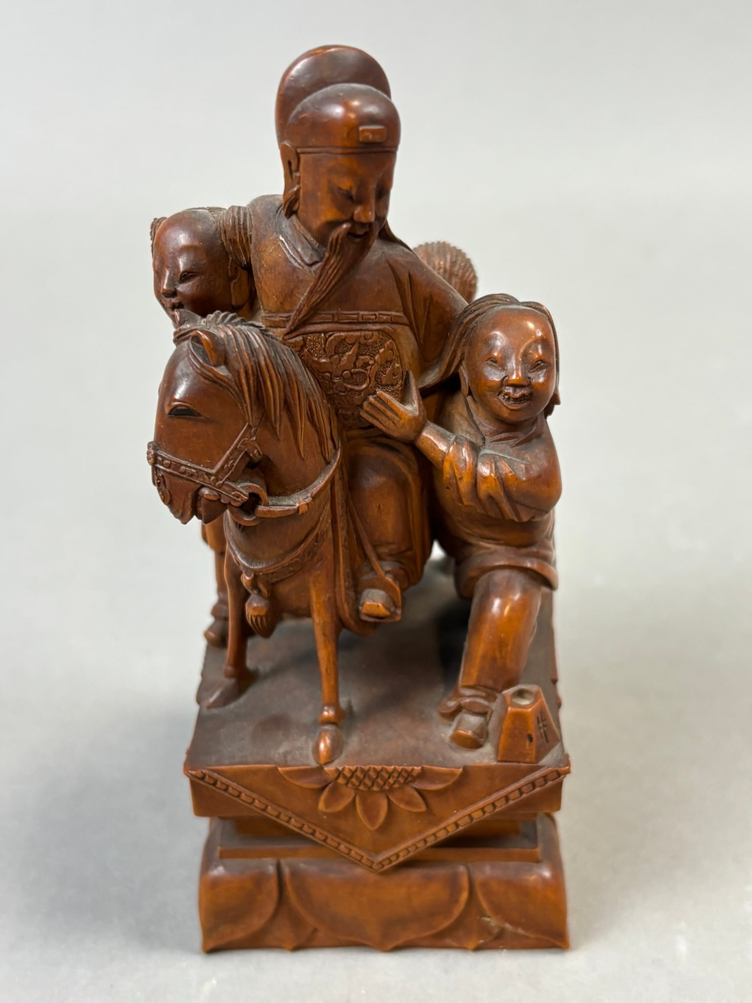 Chinese Carved Wood Scholar Riding Horse Figural Group Seal Mark Base: Chinese carved wood figural group depicting a bearded scholar riding a horse accompanied by attendants, likely representing a traditional longevity or scholarly return motif common in late Qing to ear