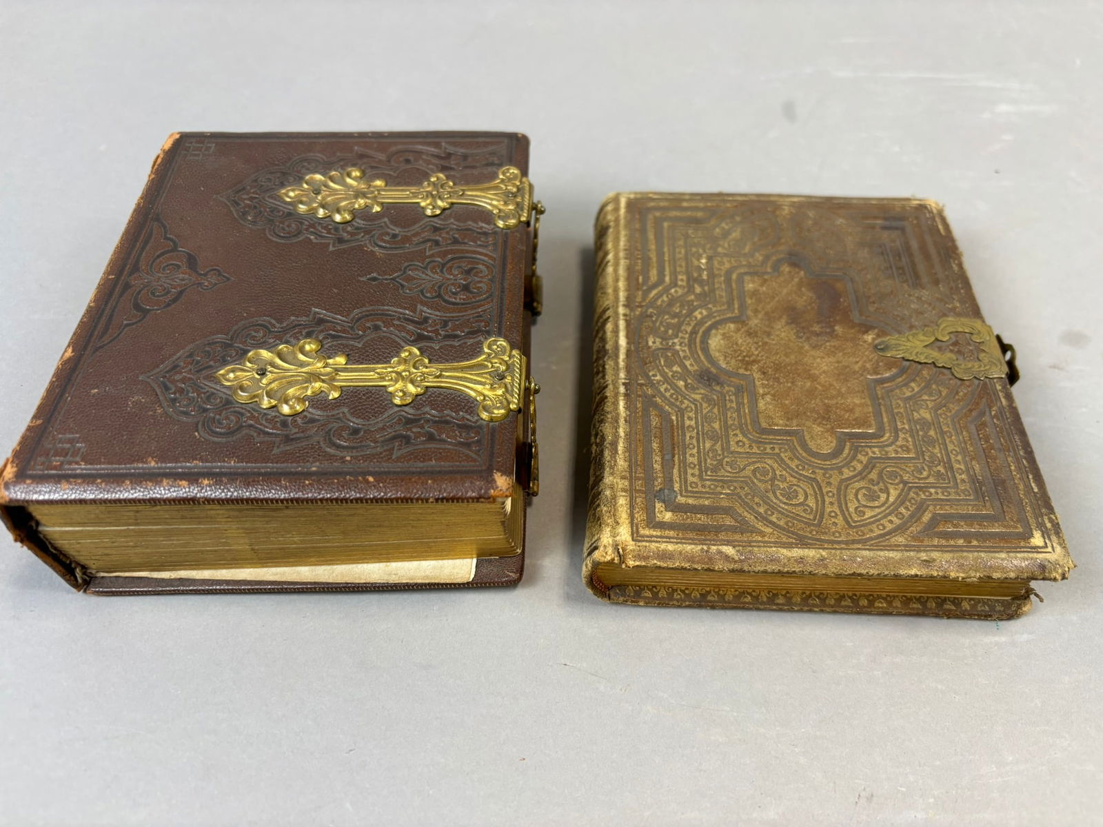 Pair Victorian Leather CDV Photograph Albums w 19th Century Portraits: Pair of Victorian leather photograph albums containing a collection of 19th century portrait photographs including albumen cartes de visite depicting men, women, and children in period attire. The lar