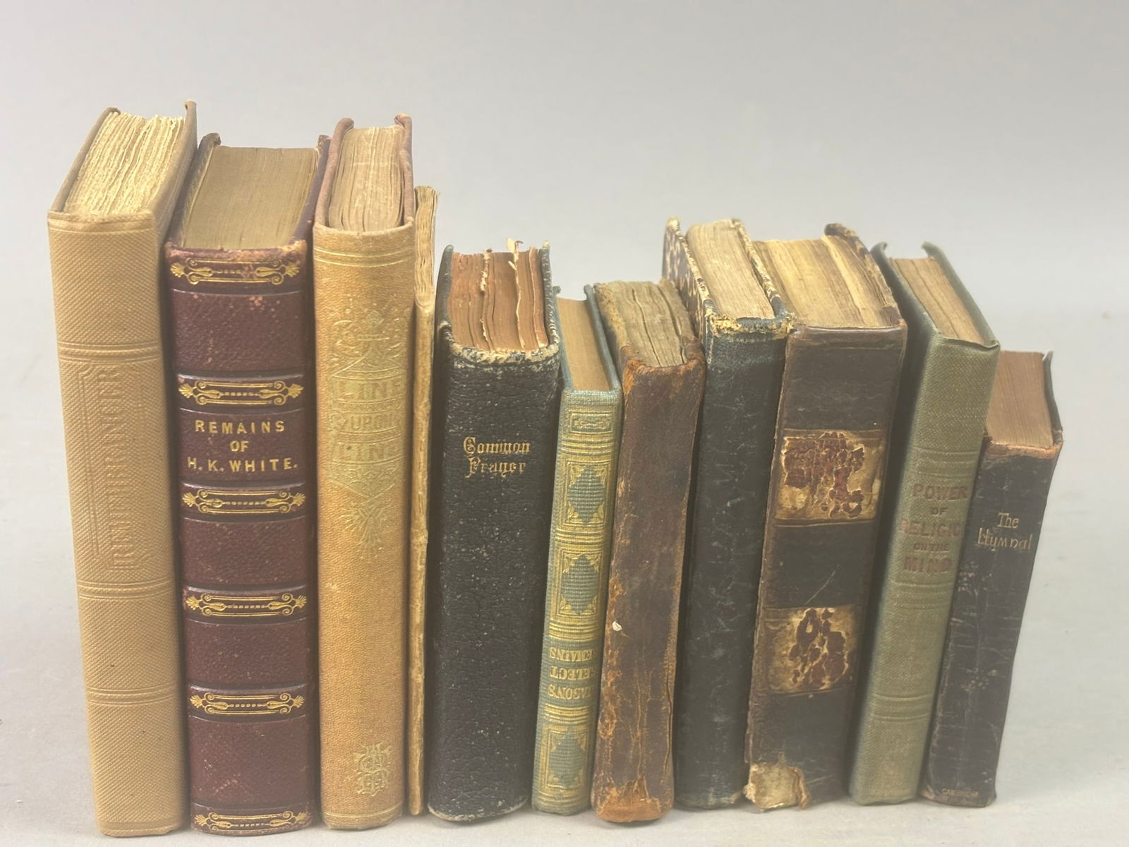 Antique Religious Devotional Books Hymnals Prayer Theology 19th C Group: Group of antique religious and devotional books dating primarily to the early and mid-19th century including works such as Remains of Henry Kirke White (Glasgow, 1837), Barbauld’s Hymns in Prose