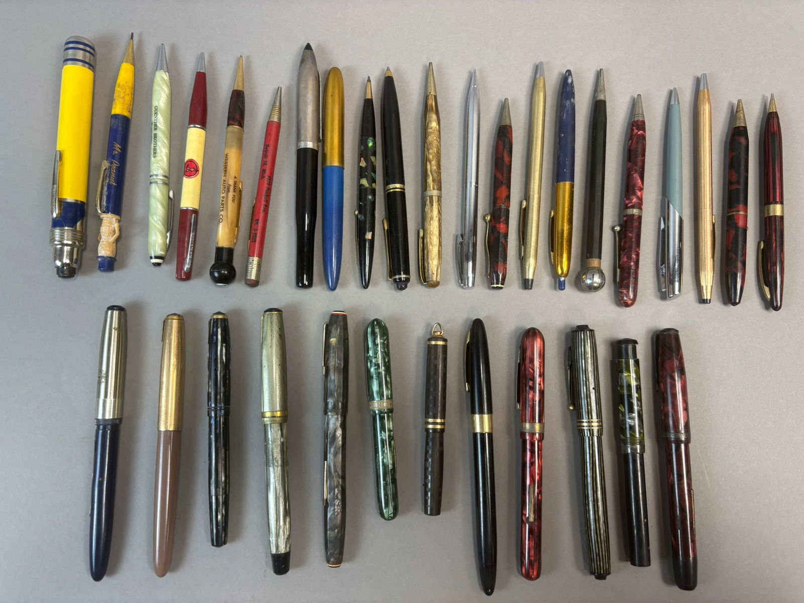 Vintage Fountain Pens Mechanical Pencils Advertising Pens Large Lot 33: Large mixed lot of thirty-three vintage writing instruments including fountain pens, mechanical pencils, and advertising ballpoint pens dating primarily to the mid 20th century. The group includes var