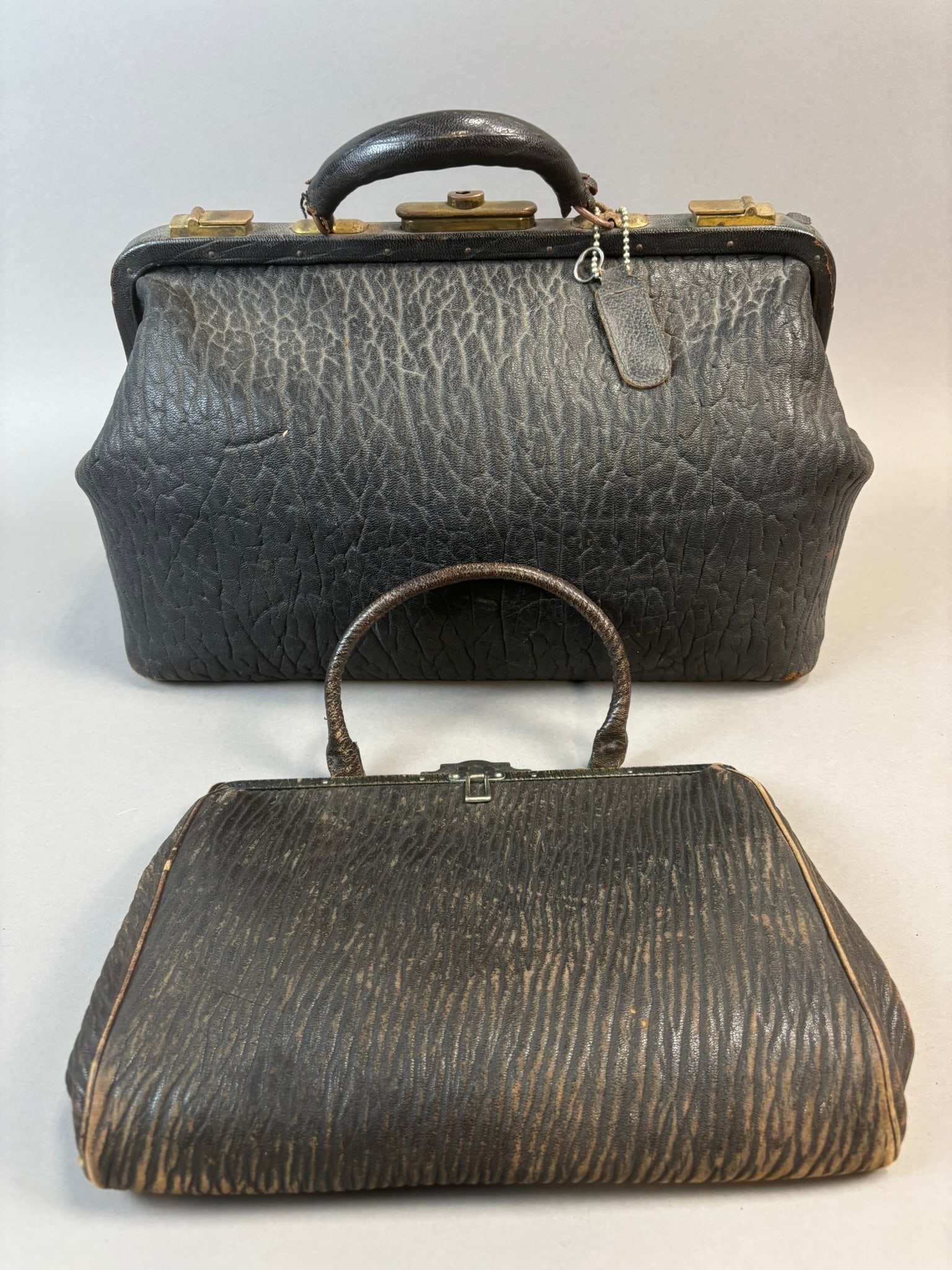 Antique Genuine Seal Walrus Leather Doctors Bag & Matching Purse Set: Antique matched leather bag set including a large doctor’s bag and smaller handbag purse, both marked “Genuine Seal Walrus” to the underside. These early 20th century bags feature te