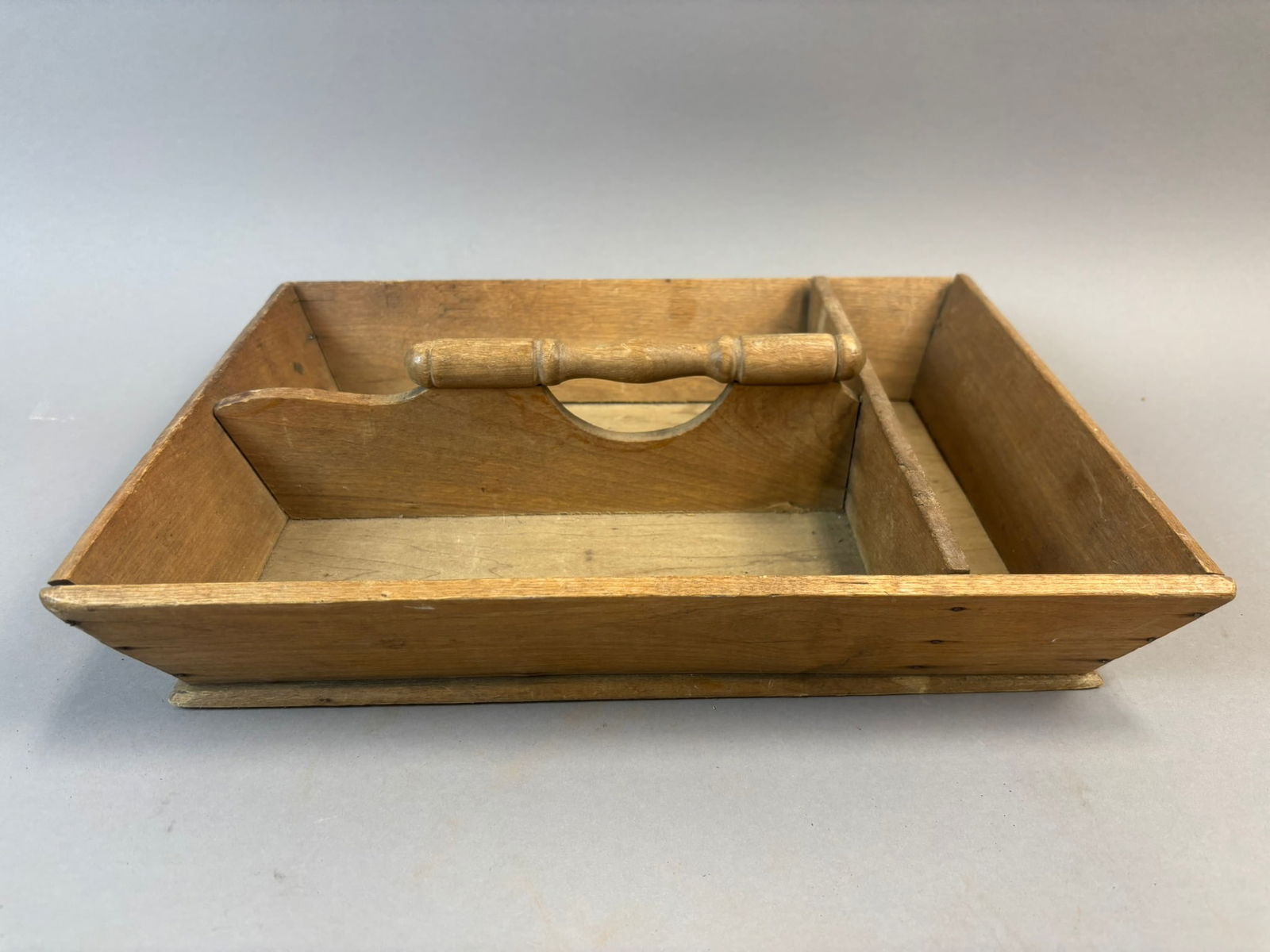 Antique Wood Cutlery Tote Flatware Carrier Divided Utensil Box: Antique wooden cutlery tote or flatware carrier featuring a rectangular form with divided interior compartments and a turned wood center handle for carrying. The interior is arranged with two compartm
