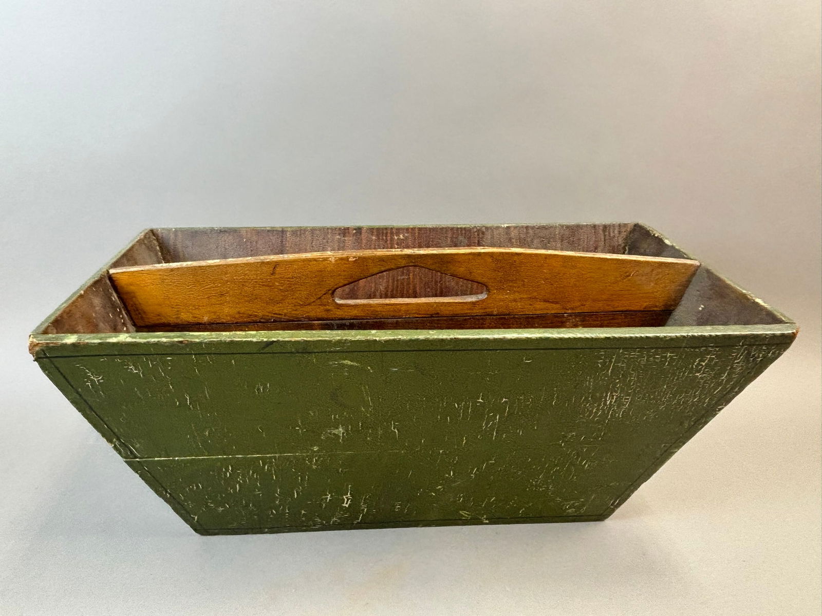Antique 19th Century Primitive Green Painted Wood Tote Carrier: Antique wooden tote featuring a rectangular form with divided interior compartments and a shaped center divider with integral hand grip. The exterior retains an old green painted surface with visible