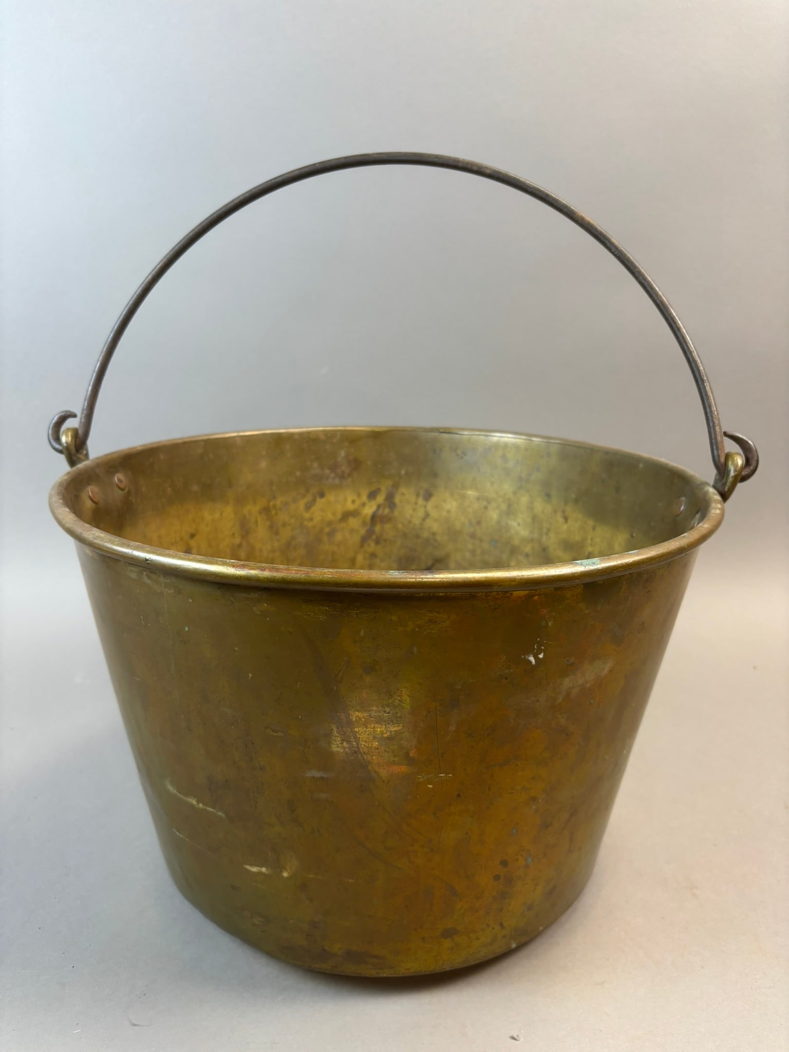 Antique Brass Coal Ash Bucket Bail Handle Marked 14 American Brass: Antique brass coal or ash bucket featuring a classic tapered form with rolled rim and iron bail handle attached through riveted brass mounts marked “14.” The underside retains a maker̵