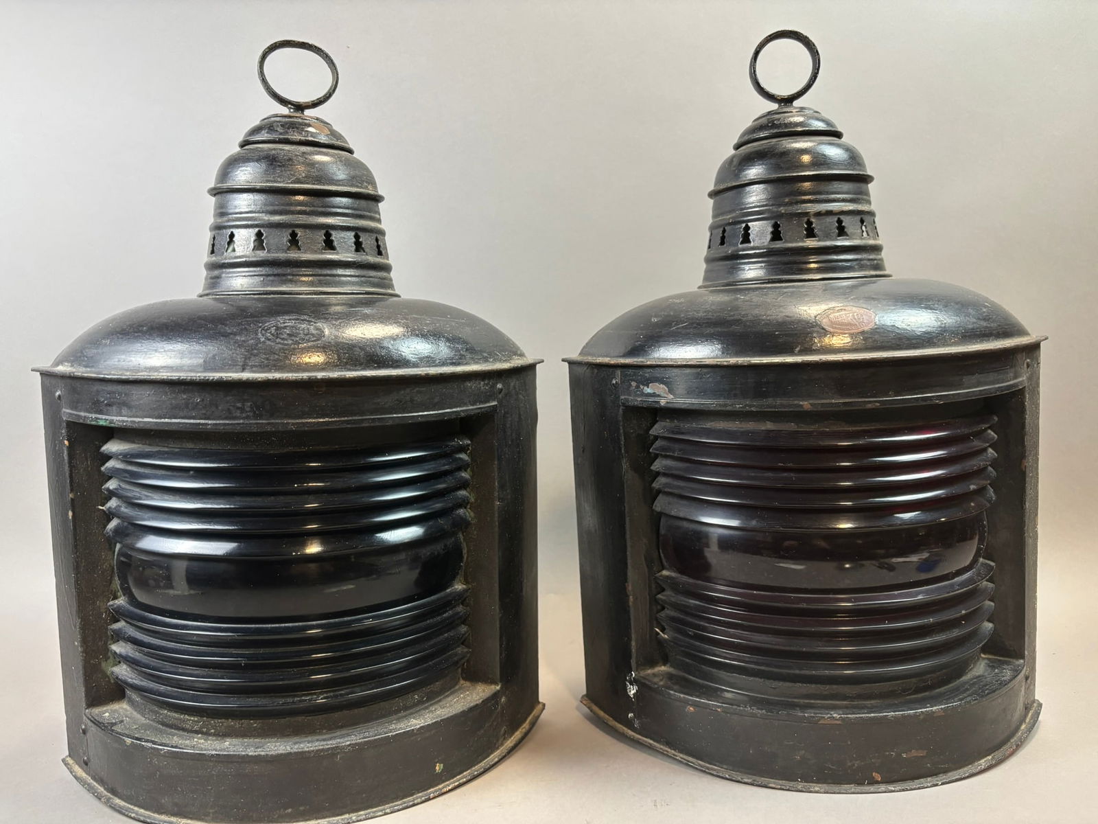 Pair Perkins Marine Ship Lanterns Red & Green Glass Navigation Lights: Matched pair of antique marine navigation lanterns by Perkins Marine Lamp & Hardware Corp., Brooklyn, N.Y., featuring original red and green Fresnel glass lenses used to indicate port and starboard po