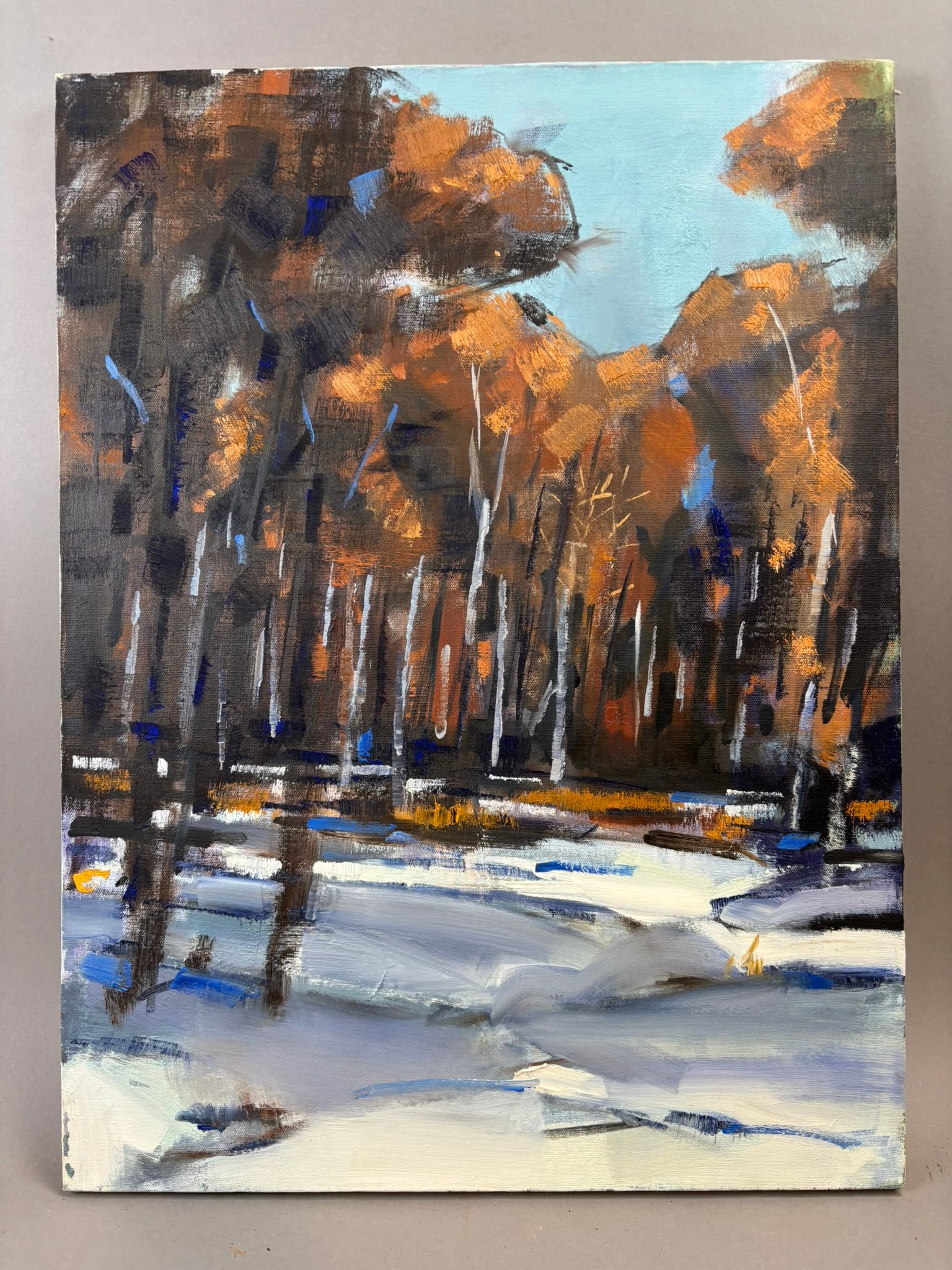 Henry Schafer Jackson Michigan Winter Landscape Oil Painting 18x24: Oil on canvas winter landscape painting by Jackson, Michigan artist Henry Schafer depicting a snowy woodland scene with tall trees and warm autumn foliage tones contrasting against snow-covered ground