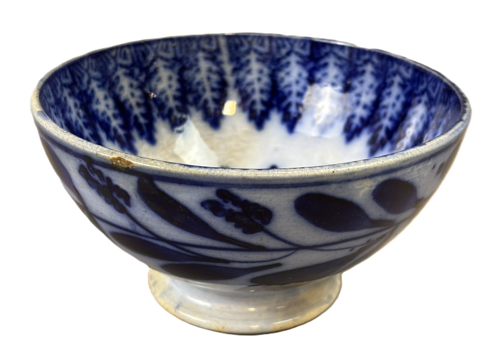 19th C Cobalt Decorated Stoneware Bowl Feather Pattern KB Pottery Mark: 19th century hand thrown stoneware bowl decorated with cobalt slip floral motifs to the exterior and a feather or fern sponge pattern to the interior surrounding a central medallion. The bowl stands o