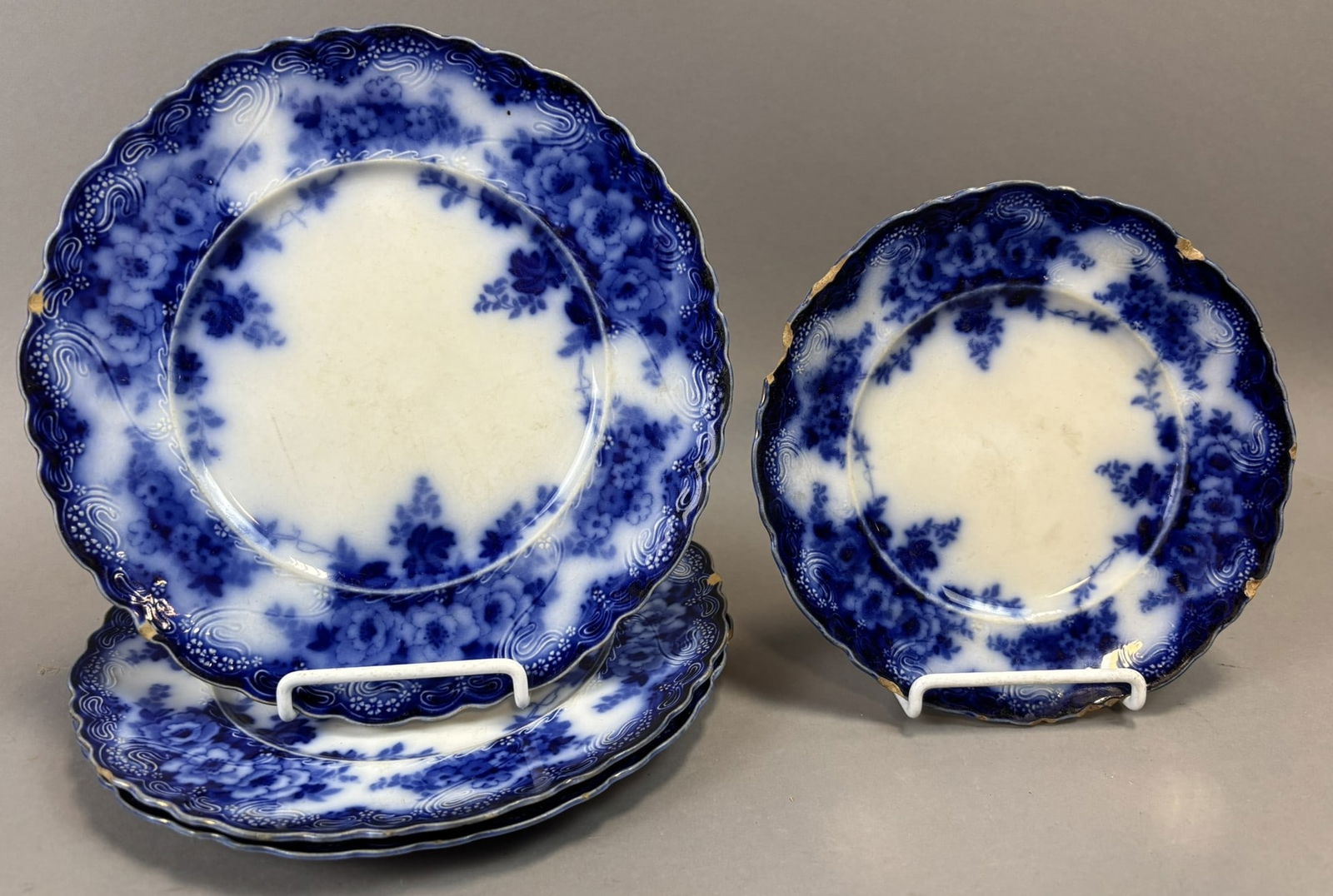 4 Alfred Meakin Devon Flow Blue Plates Staffordshire Floral Scalloped: Group of four antique English flow blue porcelain plates by Alfred Meakin, Staffordshire, England, in the Devon pattern. Each plate features a richly saturated cobalt flow blue floral border with scro
