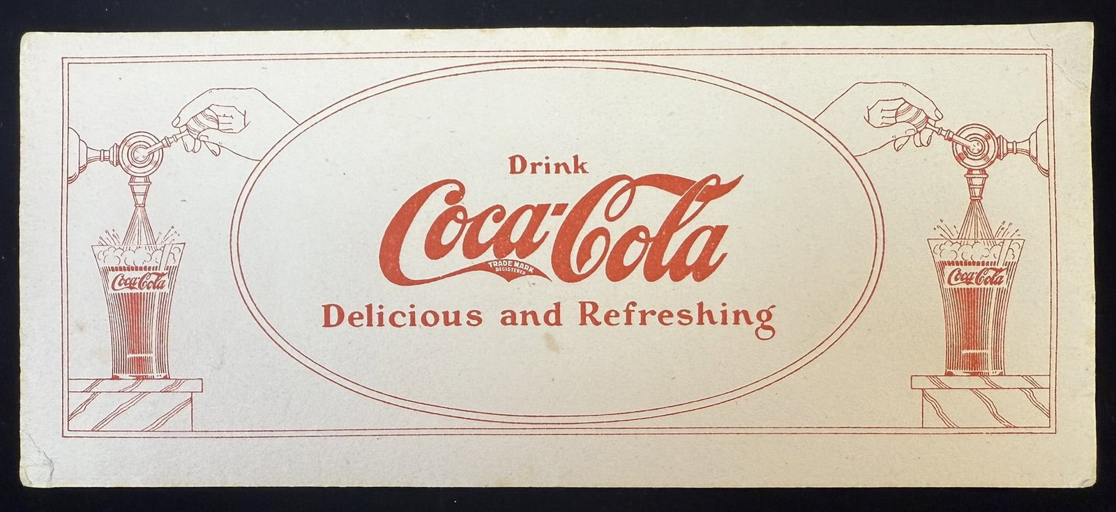 Drink Coca Cola Delicious & Refreshing Soda Jerk Ink Blotter Early 1910s: Vintage Coca-Cola advertising card featuring the iconic 'Drink Coca-Cola Delicious and Refreshing' slogan. The card displays a red illustration of a soda fountain dispensing Coca-Cola into a branded g
