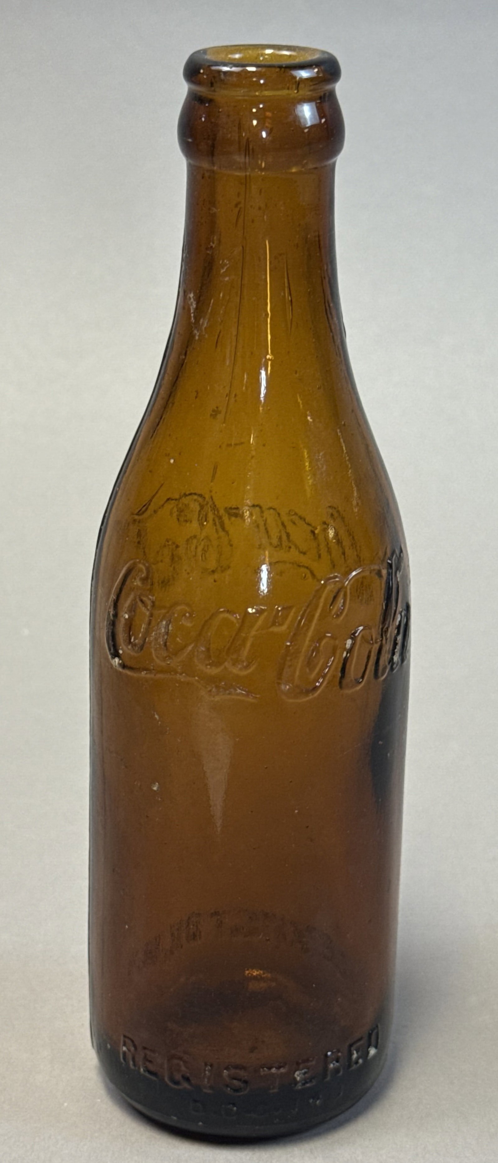 Amber Coca-Cola Bottle Lexington KY 8oz Embossed Script: Early amber glass Coca-Cola bottle embossed with the classic Coca-Cola script and lower lettering for Lexington, Kentucky, along with ?Contents 8 FL. OZ.? indicating an early pre-contour era bottle. T