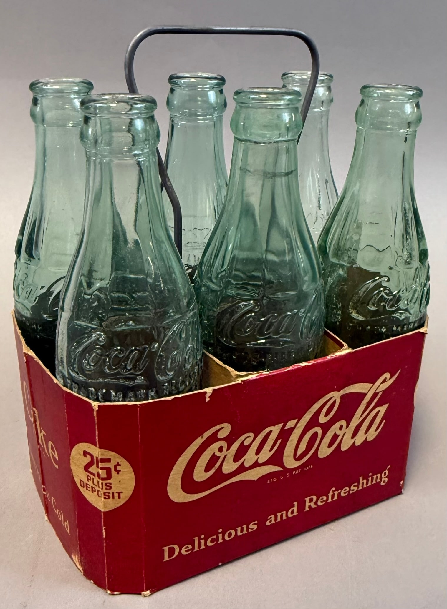 Vintage Coca Cola 6 Pack Carrier w Embossed Contour Bottles 1930s 40s: Vintage Coca-Cola six-pack cardboard bottle carrier featuring classic red graphics with ?Drink Coca-Cola,? ?Delicious and Refreshing,? and ?25? plus deposit? markings, complete with six green glass co