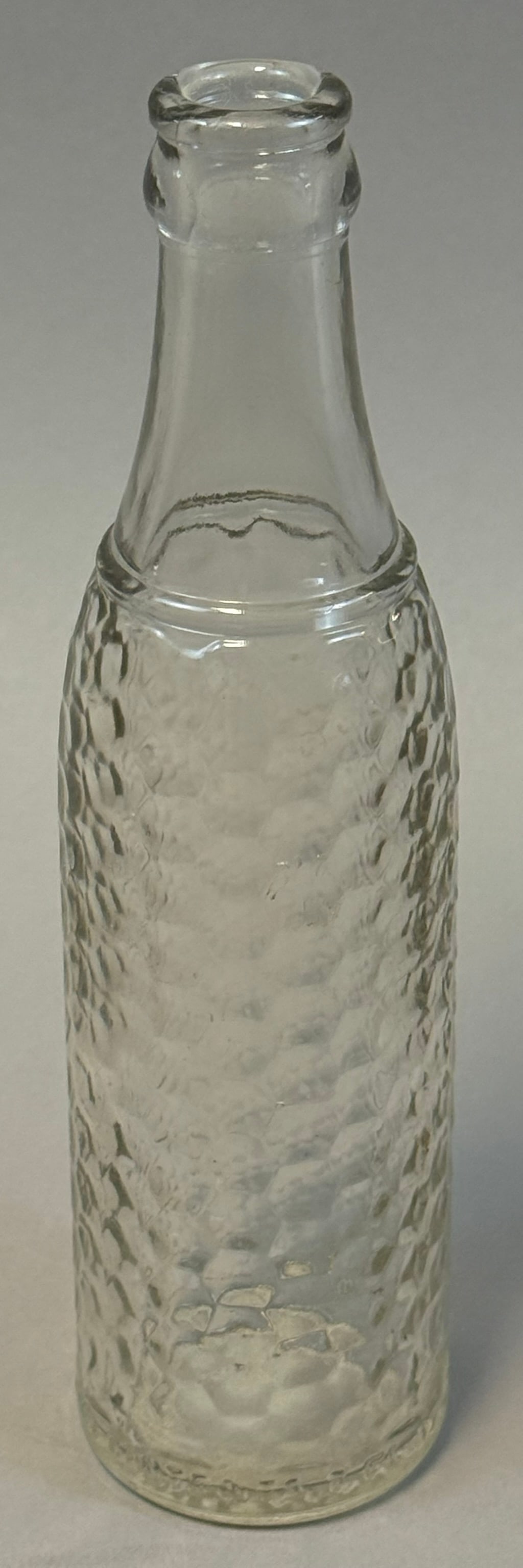 Vintage Coca Cola Hobble Skirt Bottle 6.5oz Textured Glass: Vintage Coca-Cola hobble-skirt contour bottle with classic diamond textured body and crown top lip, embossed with CONTENTS 6? FL OZ marking; mid-20th century production example showing surface wear an