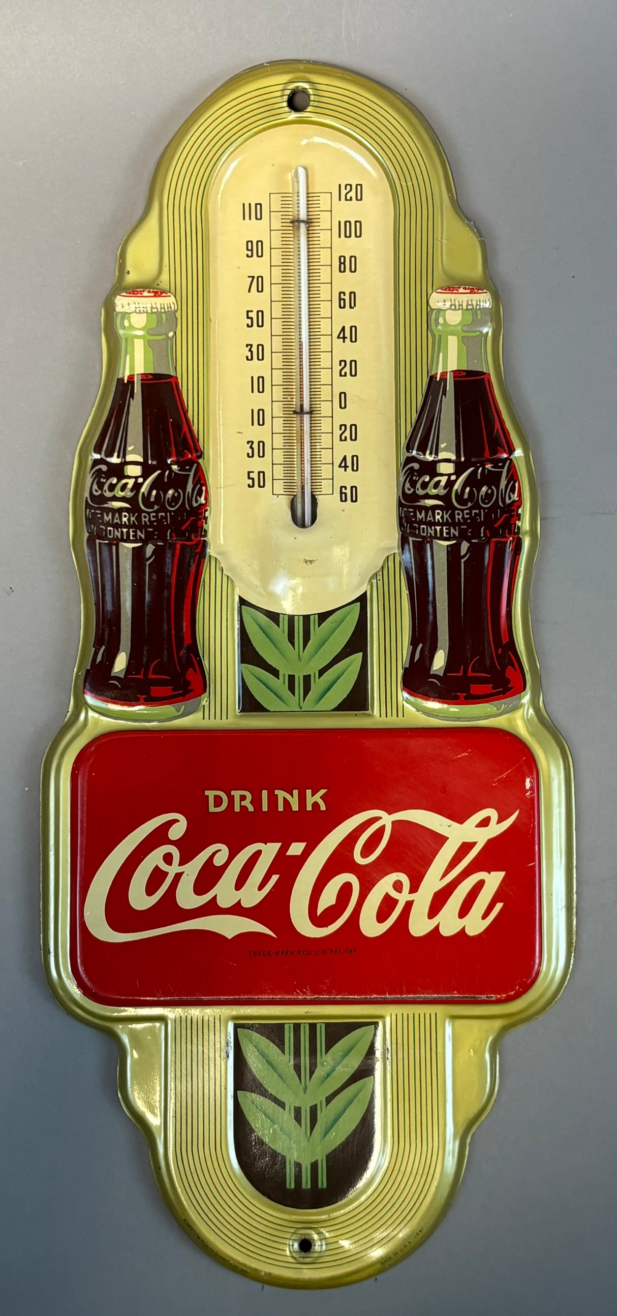 Coca-Cola Tin Thermometer w Bottle Graphics Robertson 1941 USA: Vintage Coca-Cola advertising tin thermometer manufactured by Robertson (Springfield, Ohio) dated 1941, featuring classic contour bottle graphics flanking a central Fahrenheit scale and bold red ?Drin