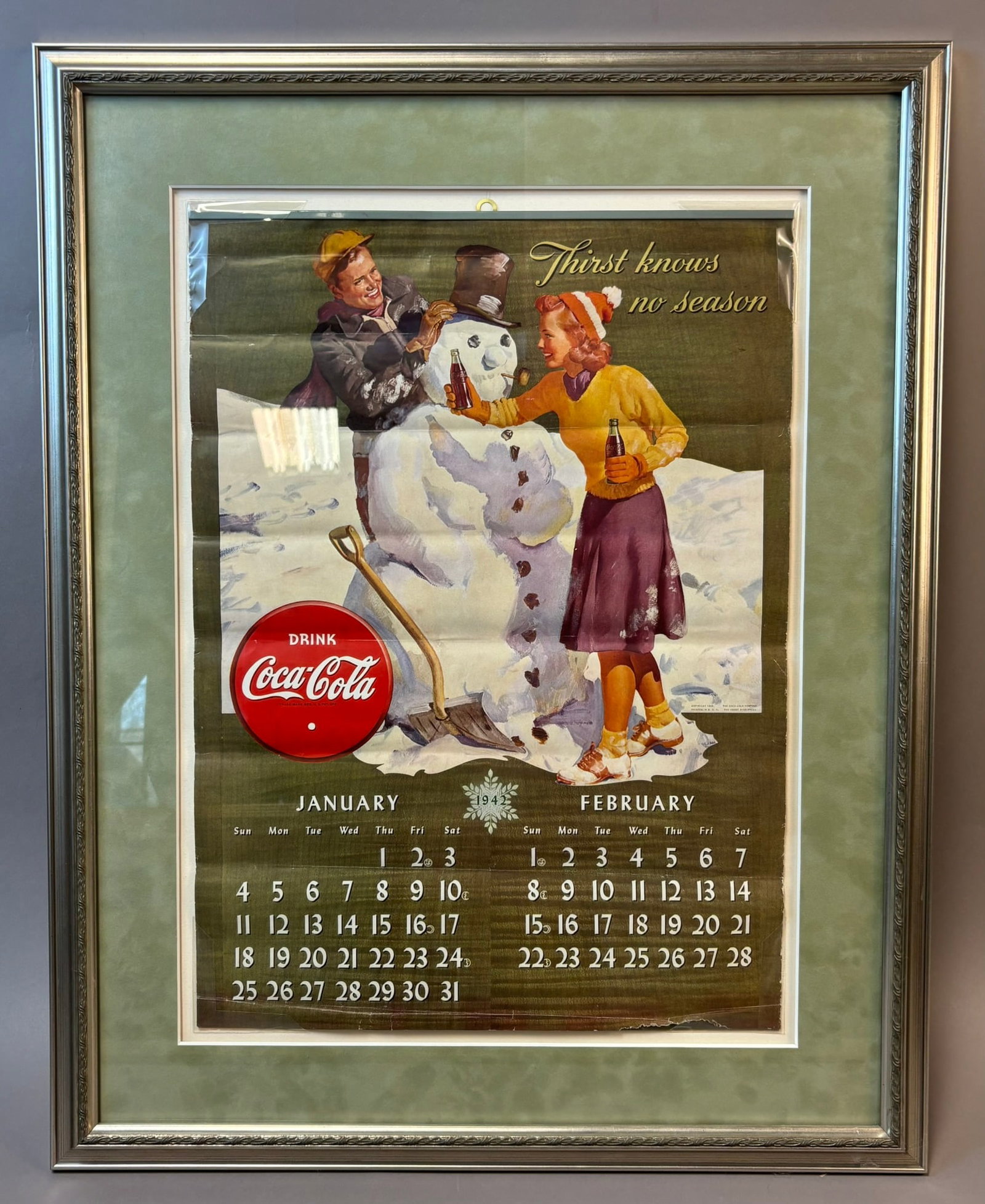 1941 Coca-Cola Calendar Poster Framed Thirst Knows No Season Display: Original 1941 Coca-Cola advertising calendar poster featuring classic winter scene with boy and girl building a snowman and the slogan ?Thirst Knows No Season,? with January and February 1942 calendar
