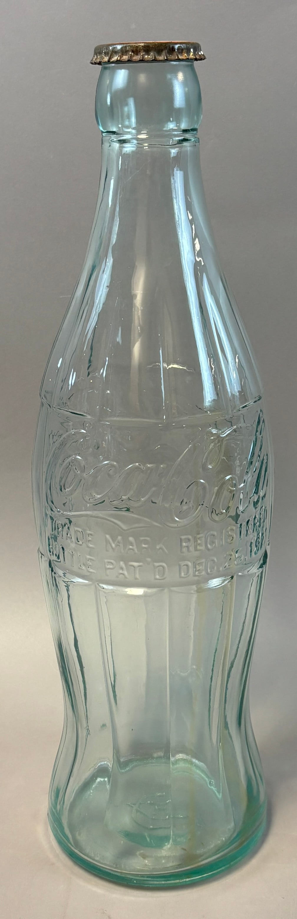 Antique Ca. 1923 20" Coca Cola Embossed Store Display Glass Bottle: Vintage Coca-Cola clear aqua glass hobble skirt bottle embossed Coca-Cola script with ?Trade Mark Registered? and ?Bottle Pat?d Dec. 25, 1923? marking, marked minimum contents 6 fluid ounces, retains 
