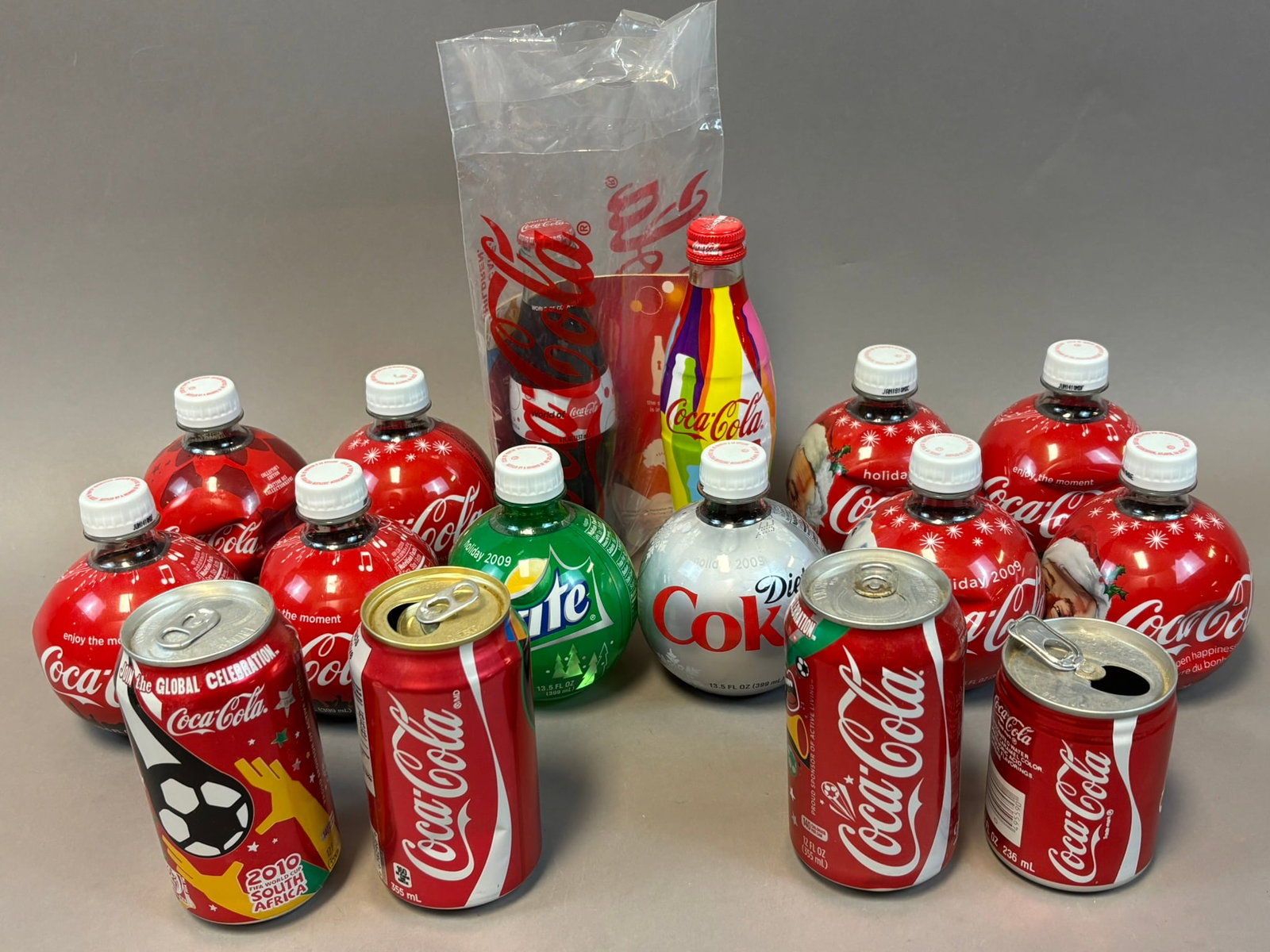 16 Piece Lot Original Coca Cola Advertising Bottles & Cans Global Celebration: See all photos
