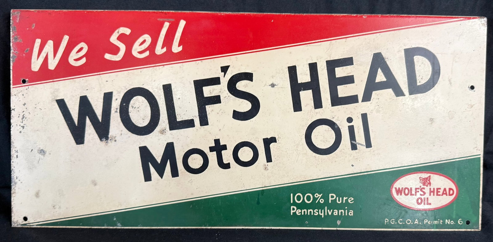 We Sell Wolf's Head Motor Oil SST Painted Metal Topper Sign: Measures 20.5" x 9.5"