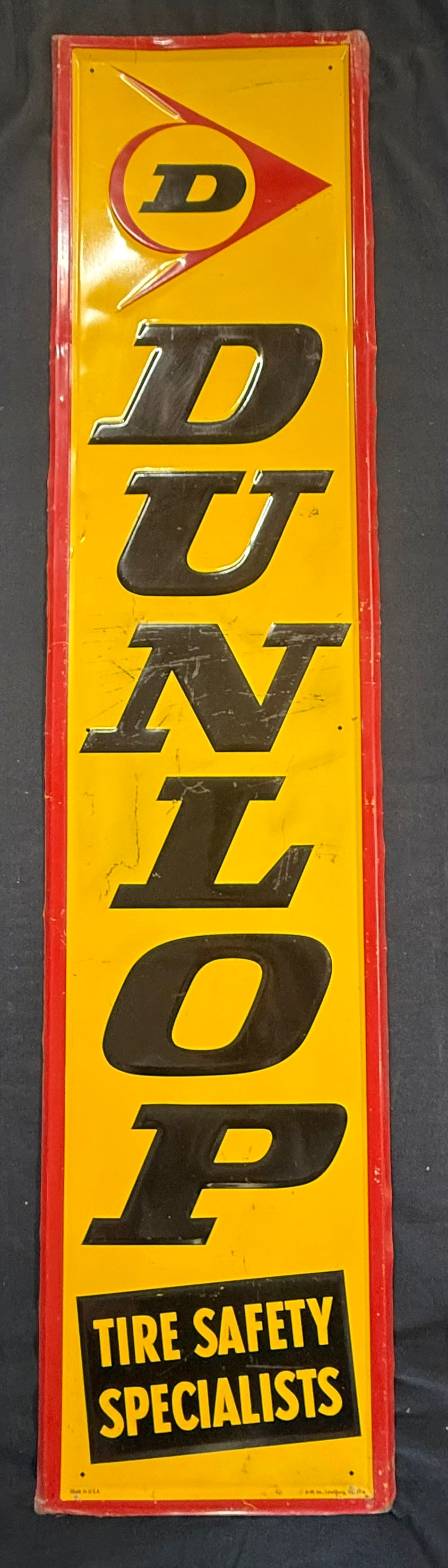 Dunlop Tire Safety Specialists Embossed Vertical Sign: Marked 5-76 A-M, Inc. Lynchburg, VA. Measures 13" x 59"