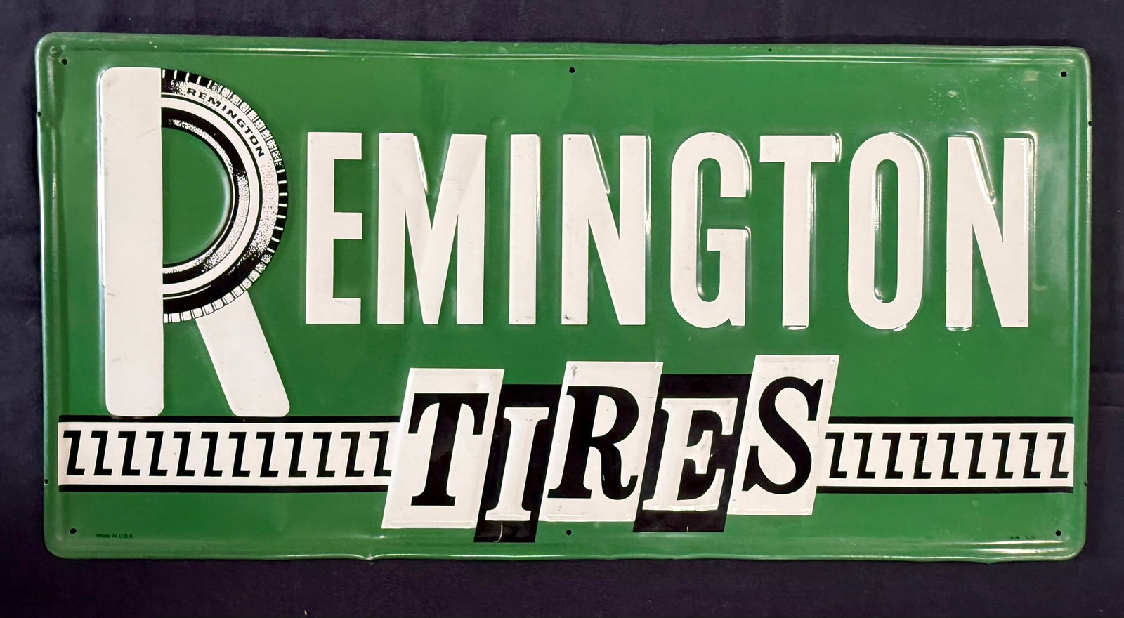 Remington Tires Original Embossed Metal Horizontal Sign: Marked A-M 3-75 Made In USA. Measures 33" x 15.5"