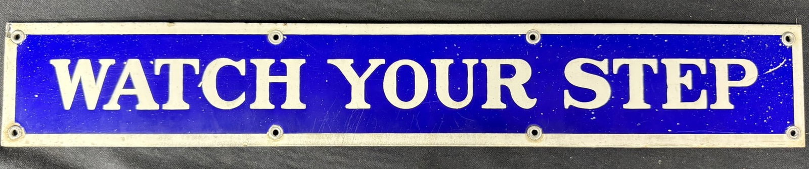 Watch Your Step SSP Porcelain Bathroom Advertising Sign: Measures 21" x 3"