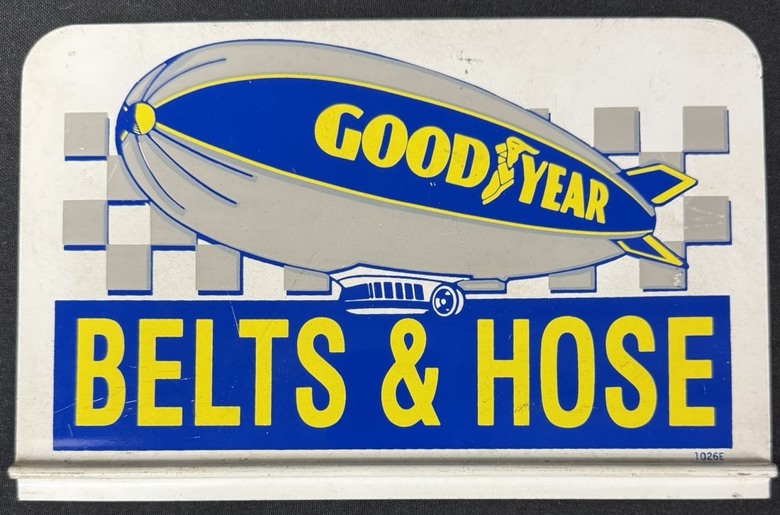 Goodyear Tires Belts & Hose SST Tin Metal Rack Topper Sign: Marked 1026E on bottom right corner. Measures 10" wide x 6.5" tall roughly